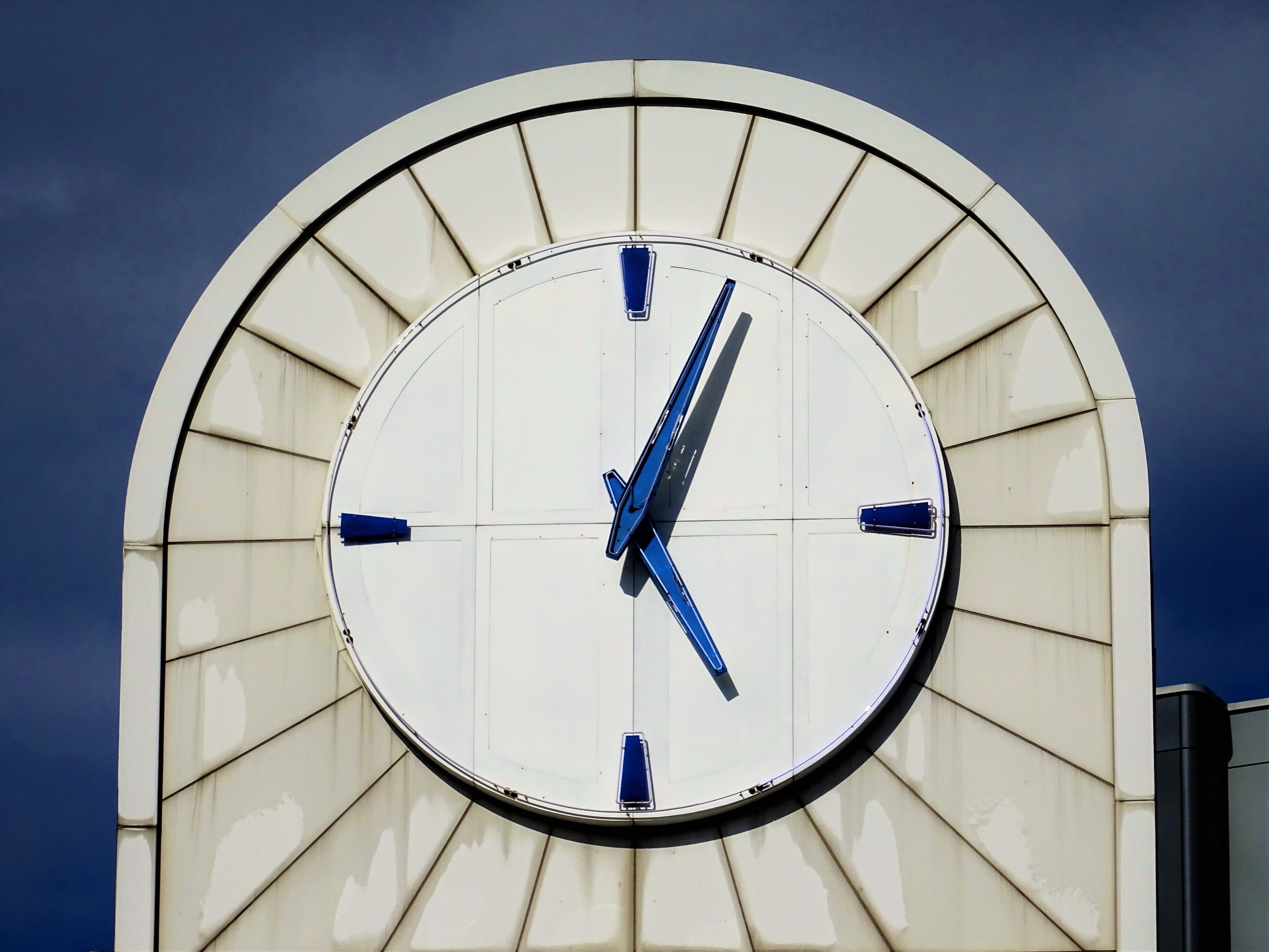 Photo of white analog building clock