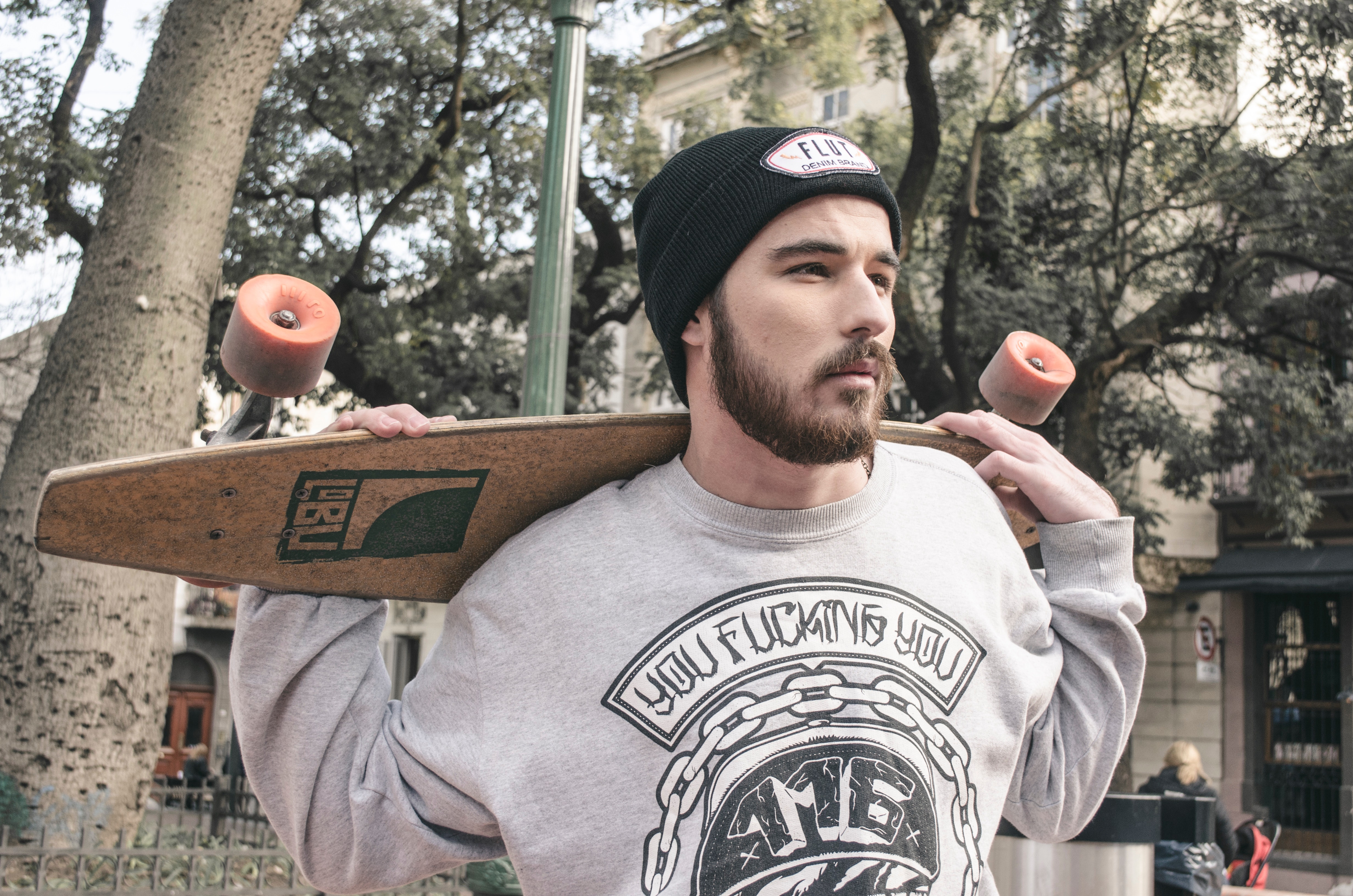 Photography of a man holding longboard