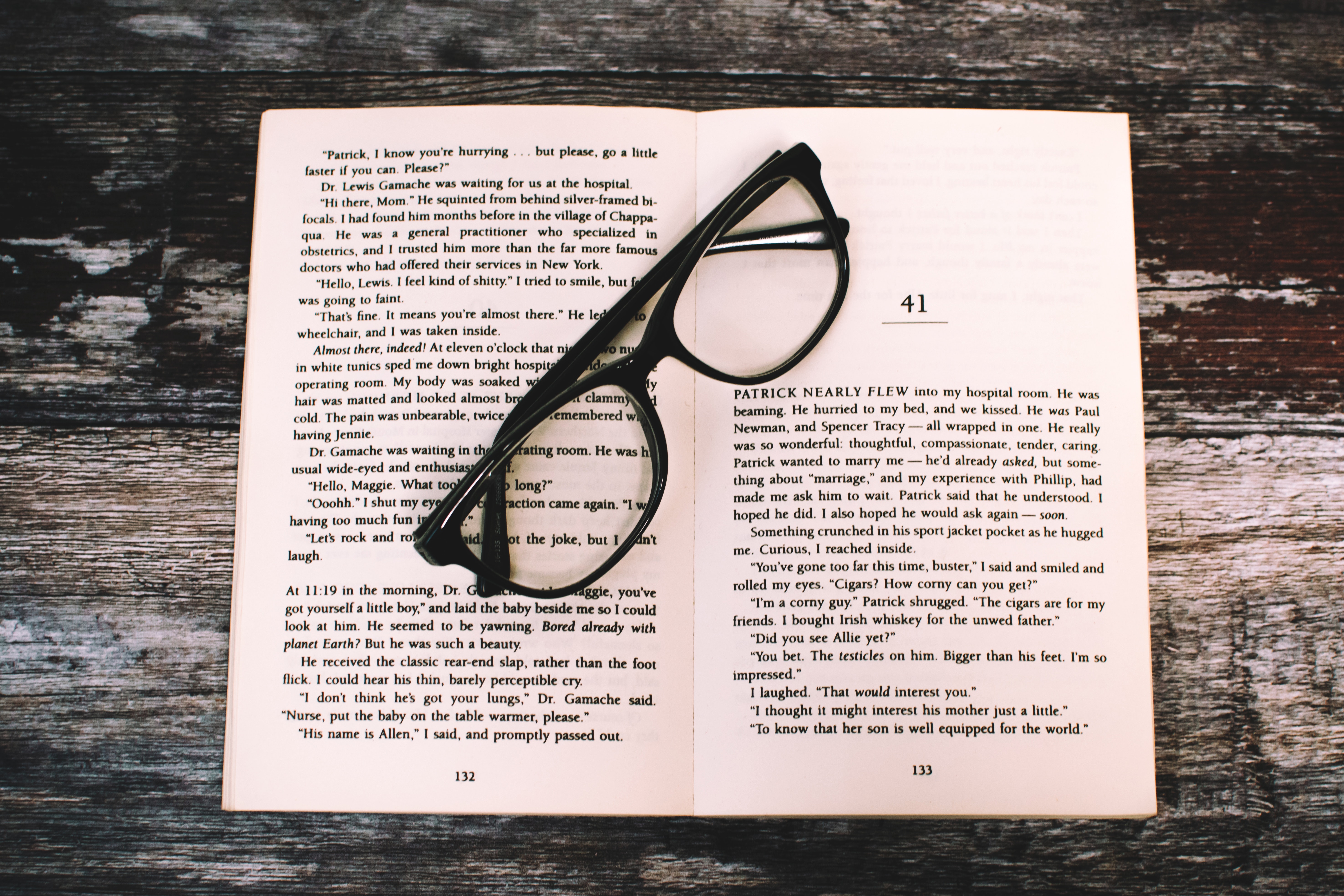 Photography of eyeglasses on top of book