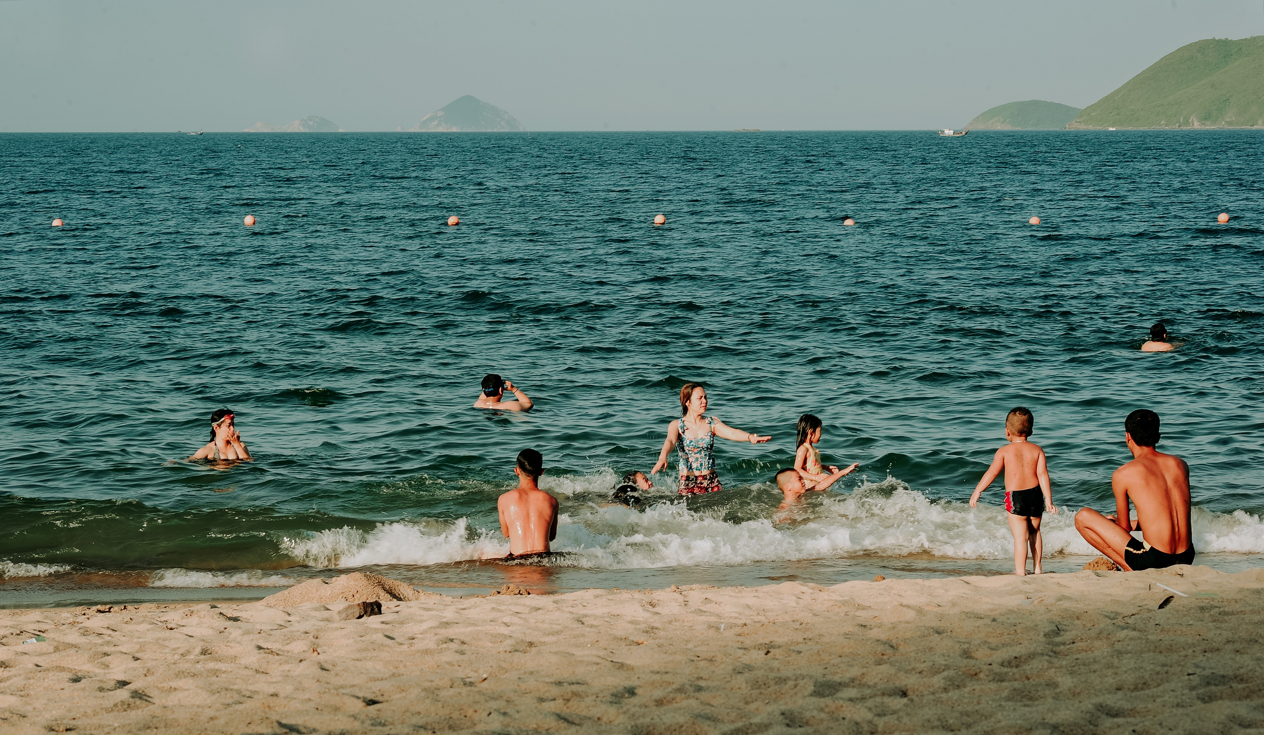 Photography of people swimming in the beach