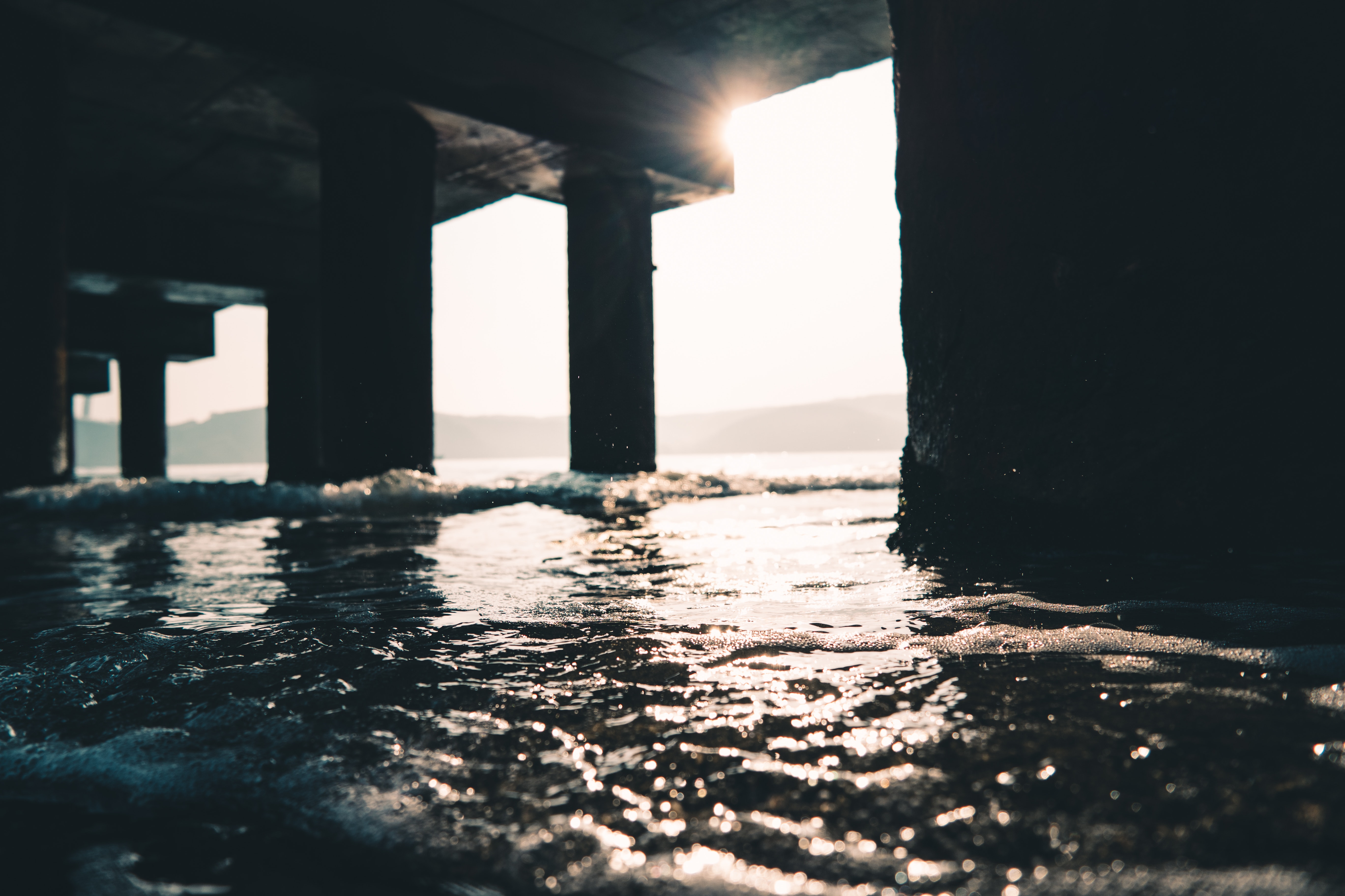 Photography of sea water under the dock