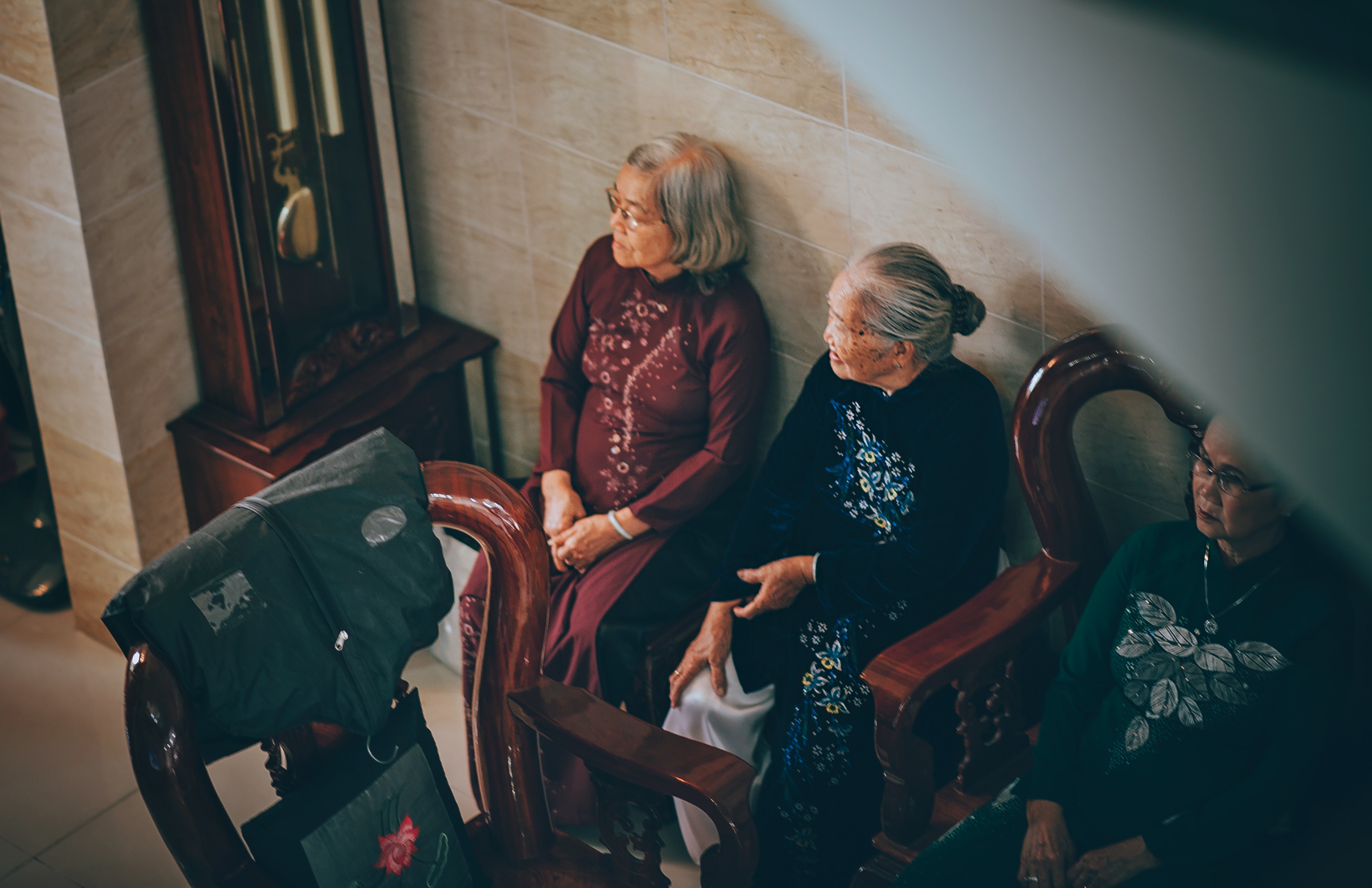 Photography of three old women sitting on chair