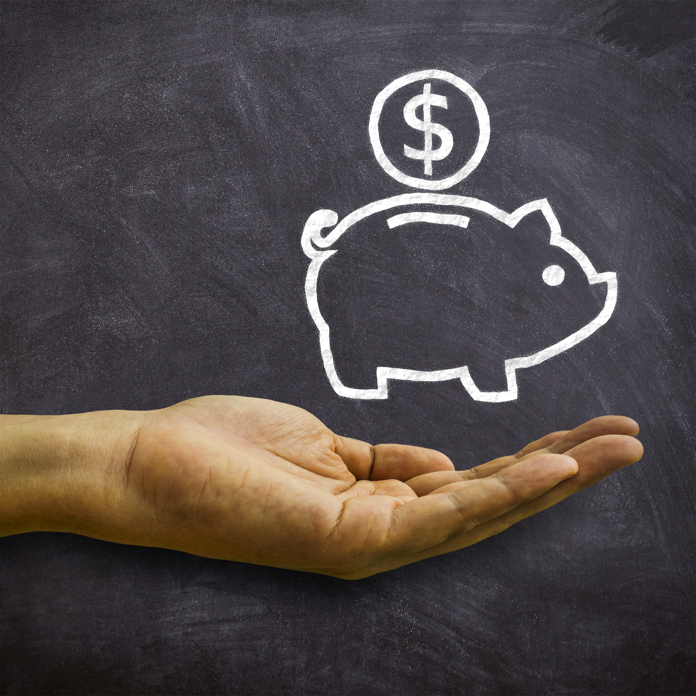 Piggy bank on blackboard - savings and economies concept photo