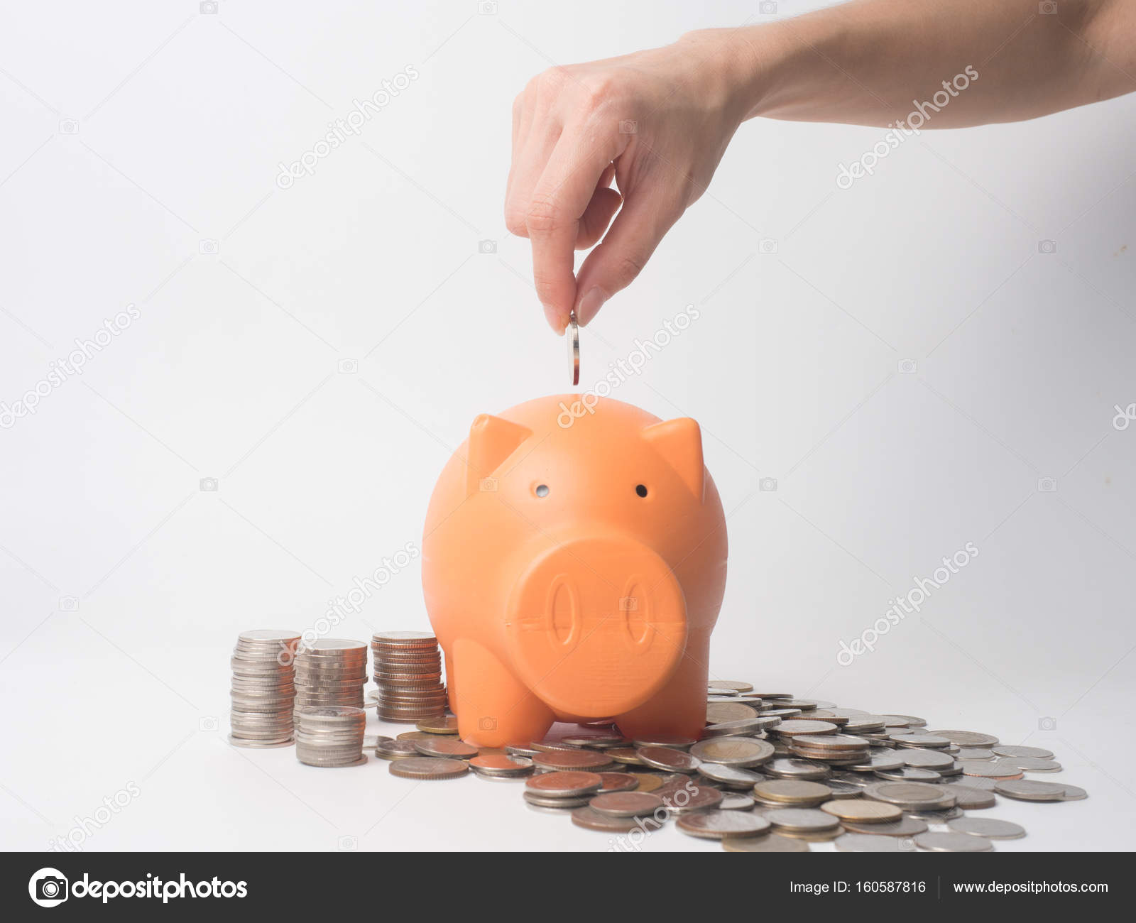 Woman Hand putting coin into piggy bank for saving with pile of ...
