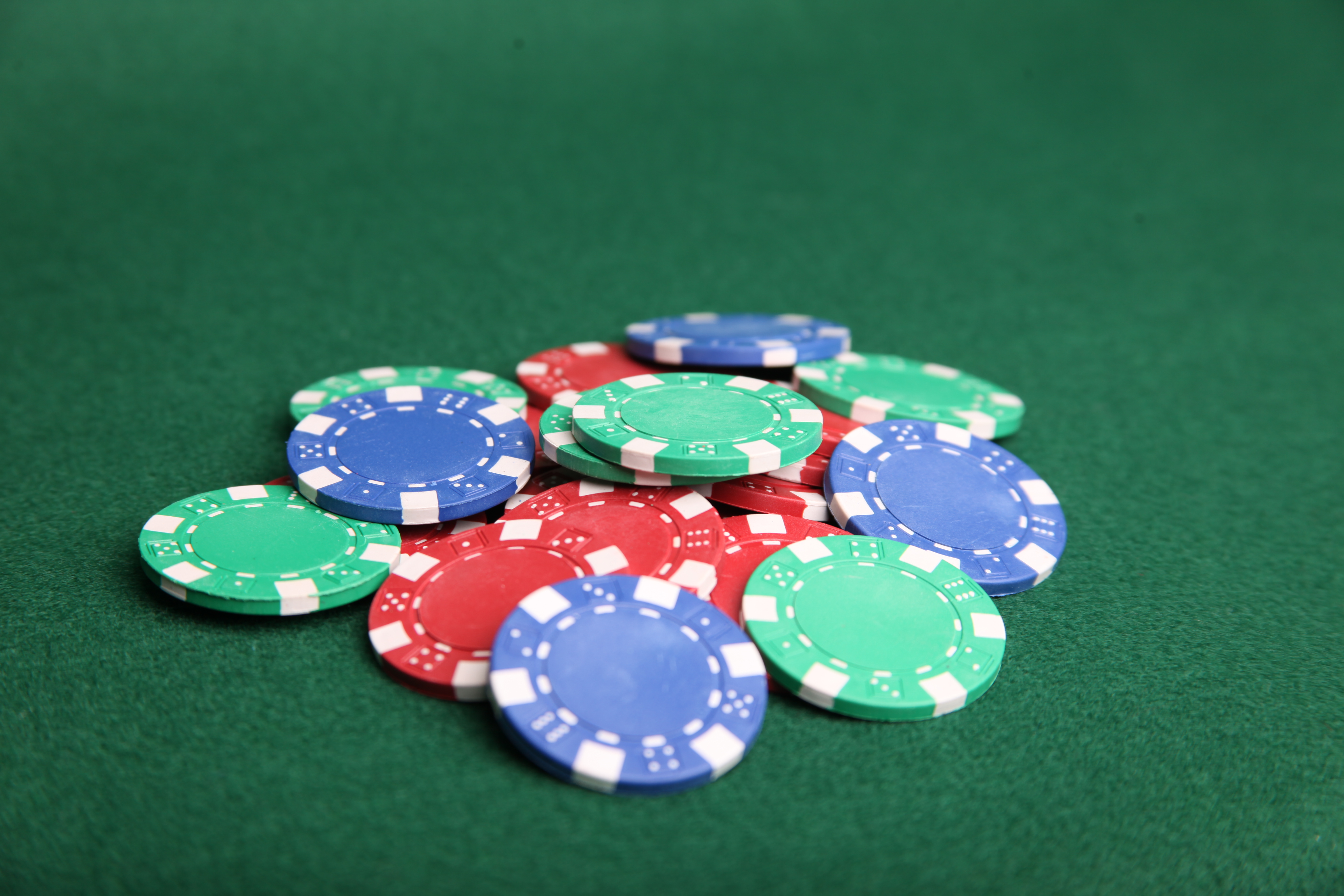 Pile of poker chips on green felt. photo
