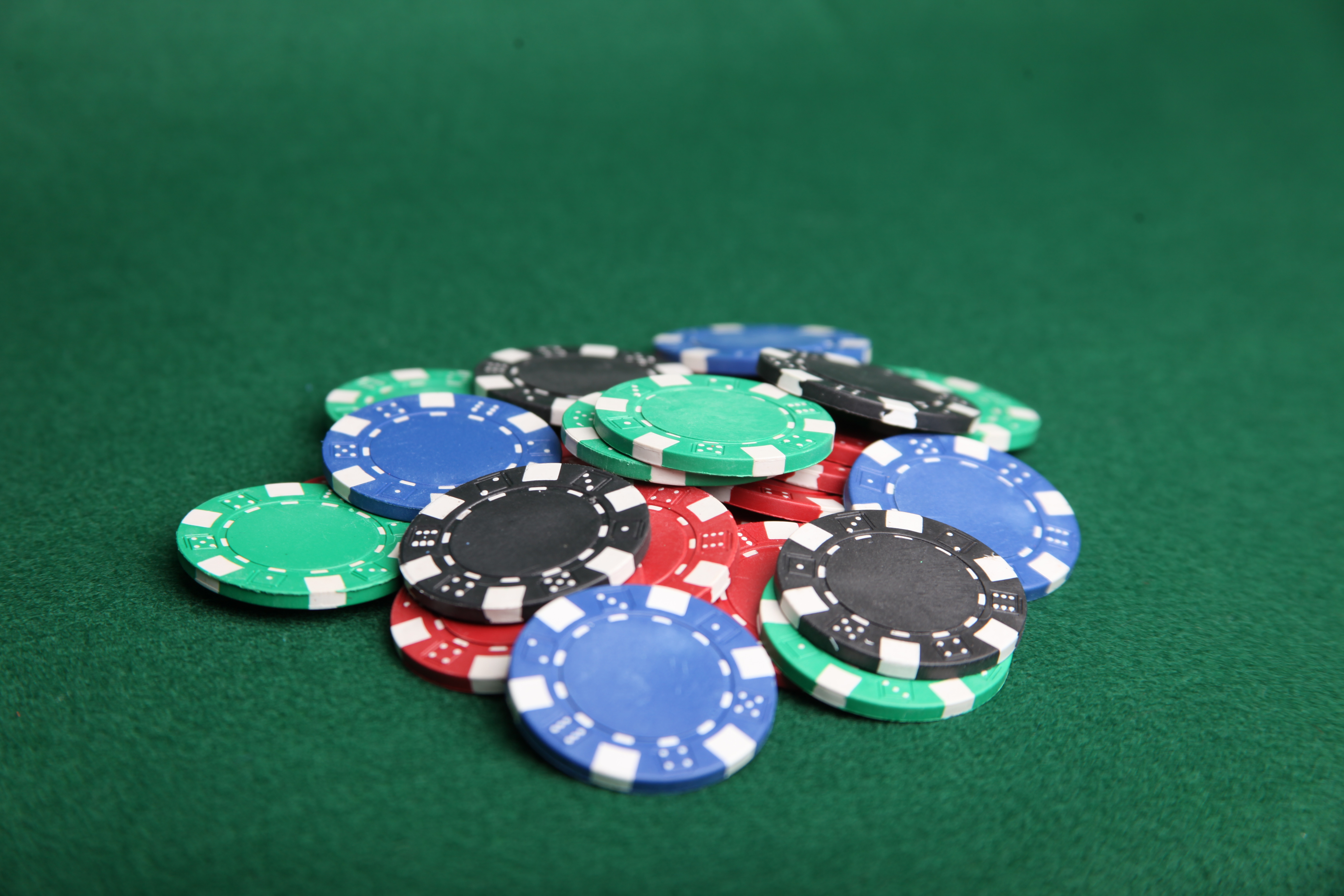 Pile of poker chips on green felt. photo