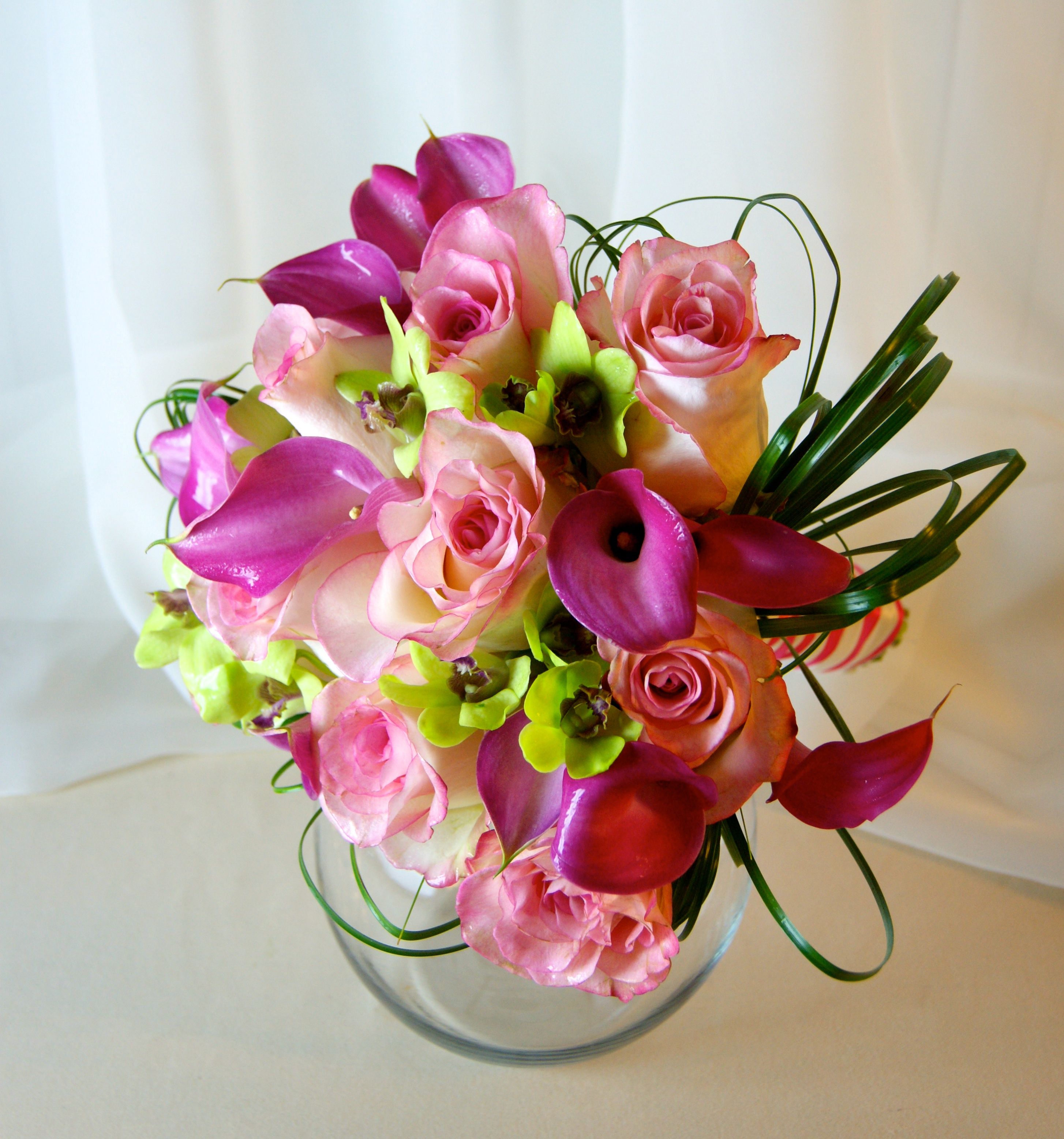 A bridal bouquet with Pink Calla Lilies and Roses accented by lime ...