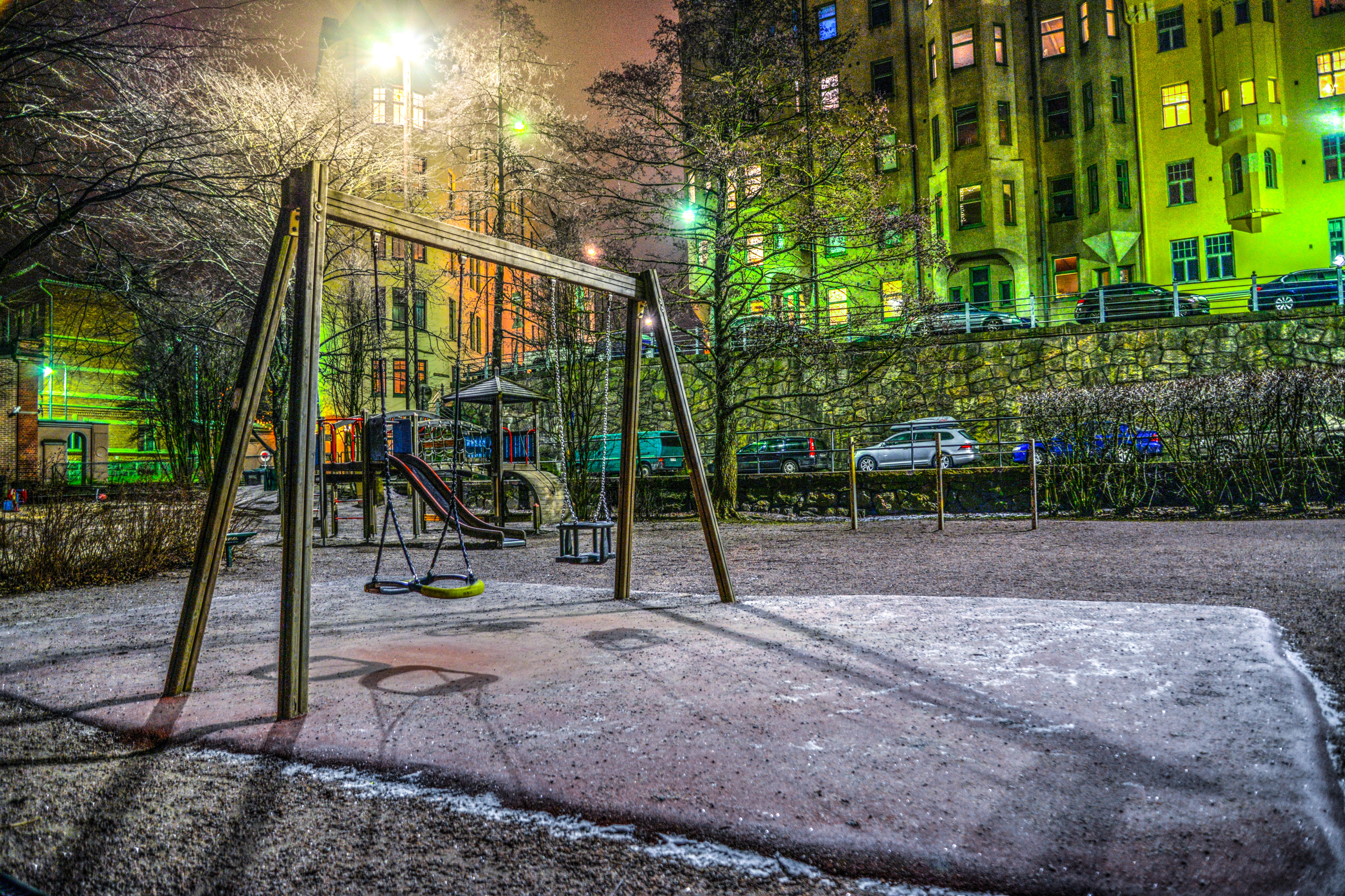 Playground surrounded with buildings and cars photo
