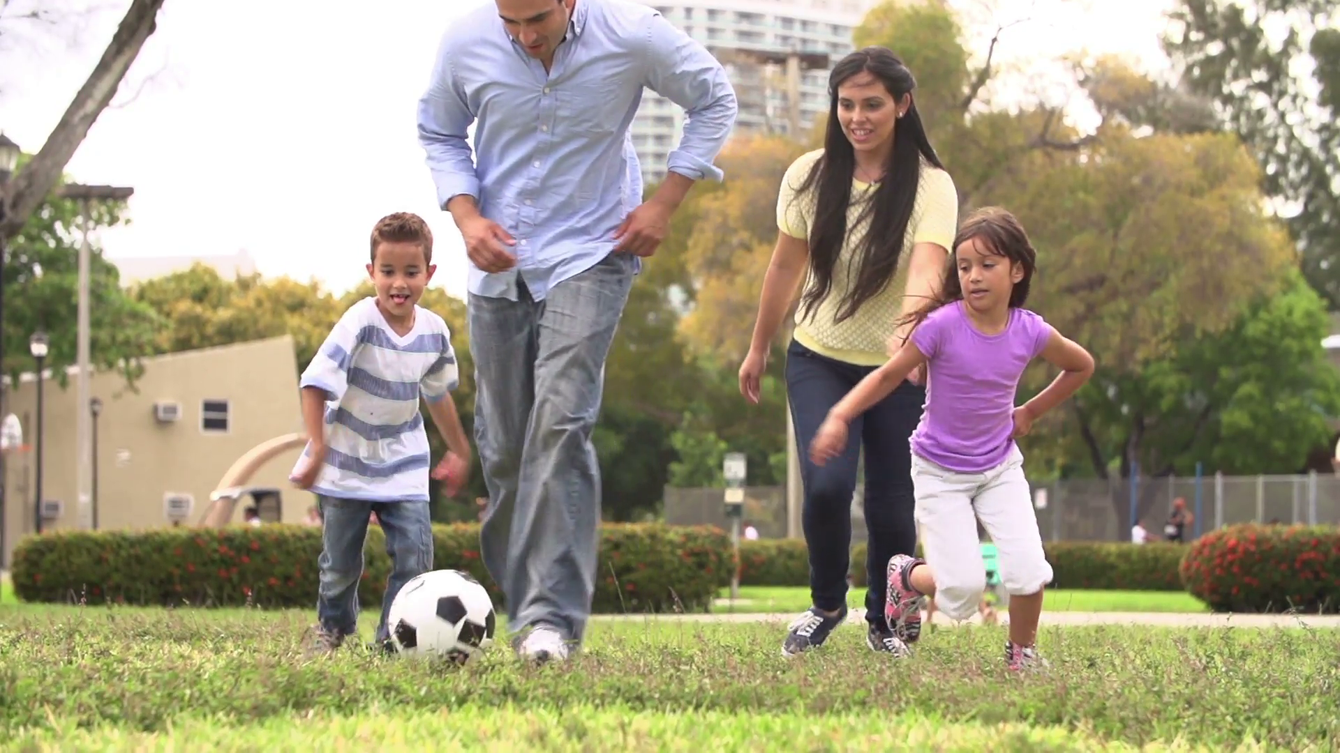 Slow Motion Shot Of Hispanic Family Playing Soccer Together Stock ...