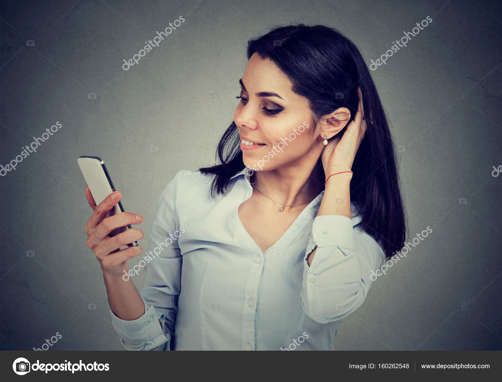 Woman reading text message on smart phone having a pleasant ...