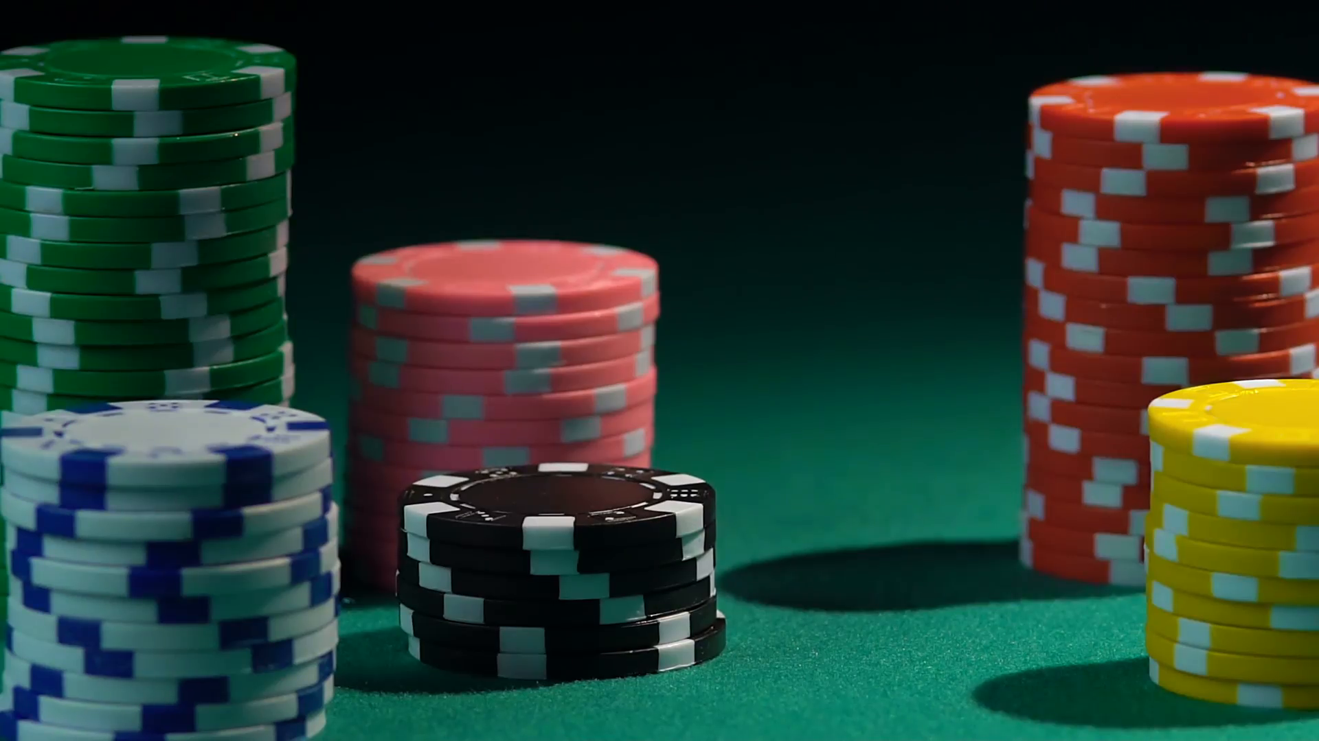 Red dice falling upon stacks of poker chips in slow motion, casino ...