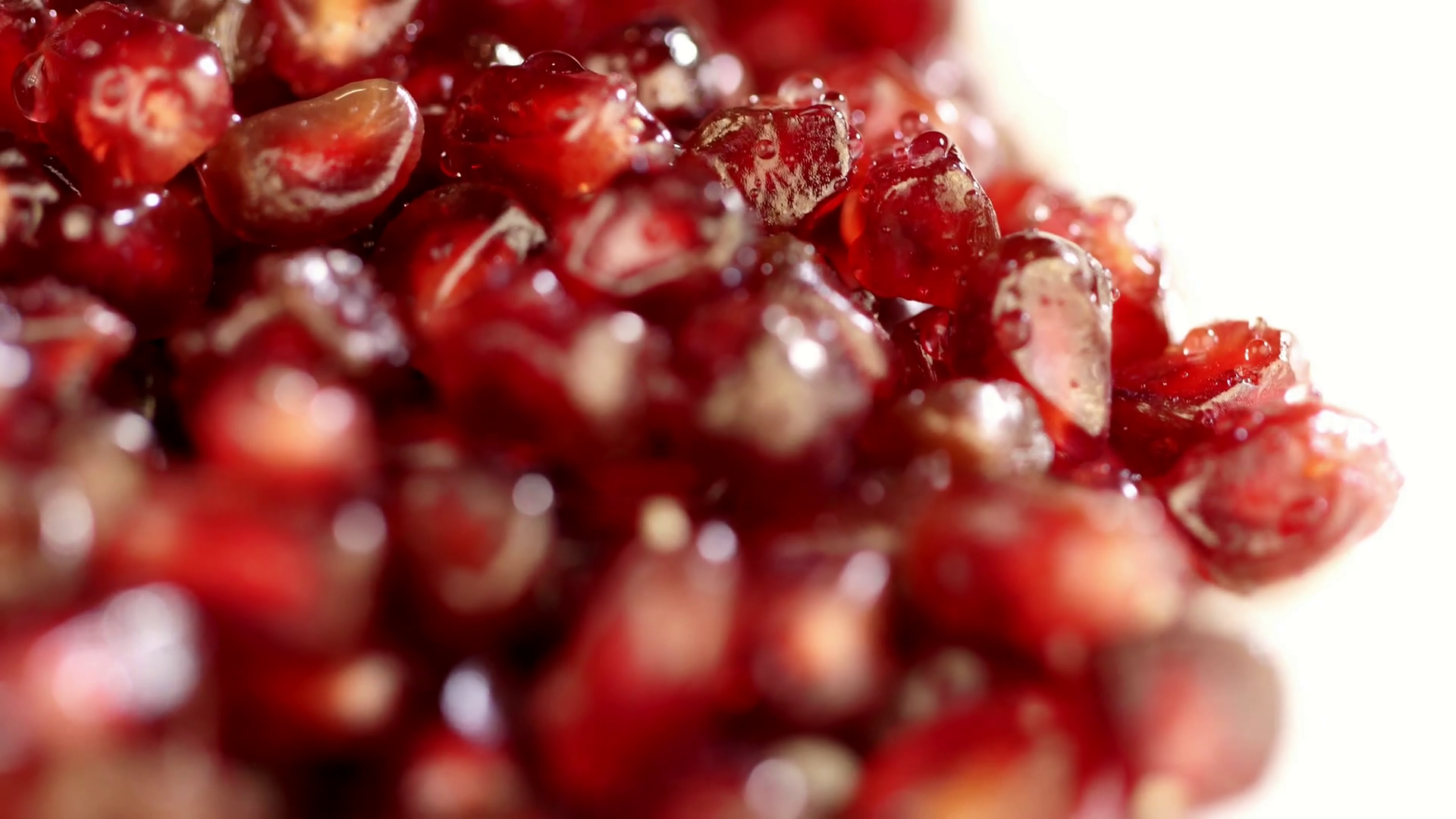 Bright juicy pomegranate. Pomegranate grains on a white background ...