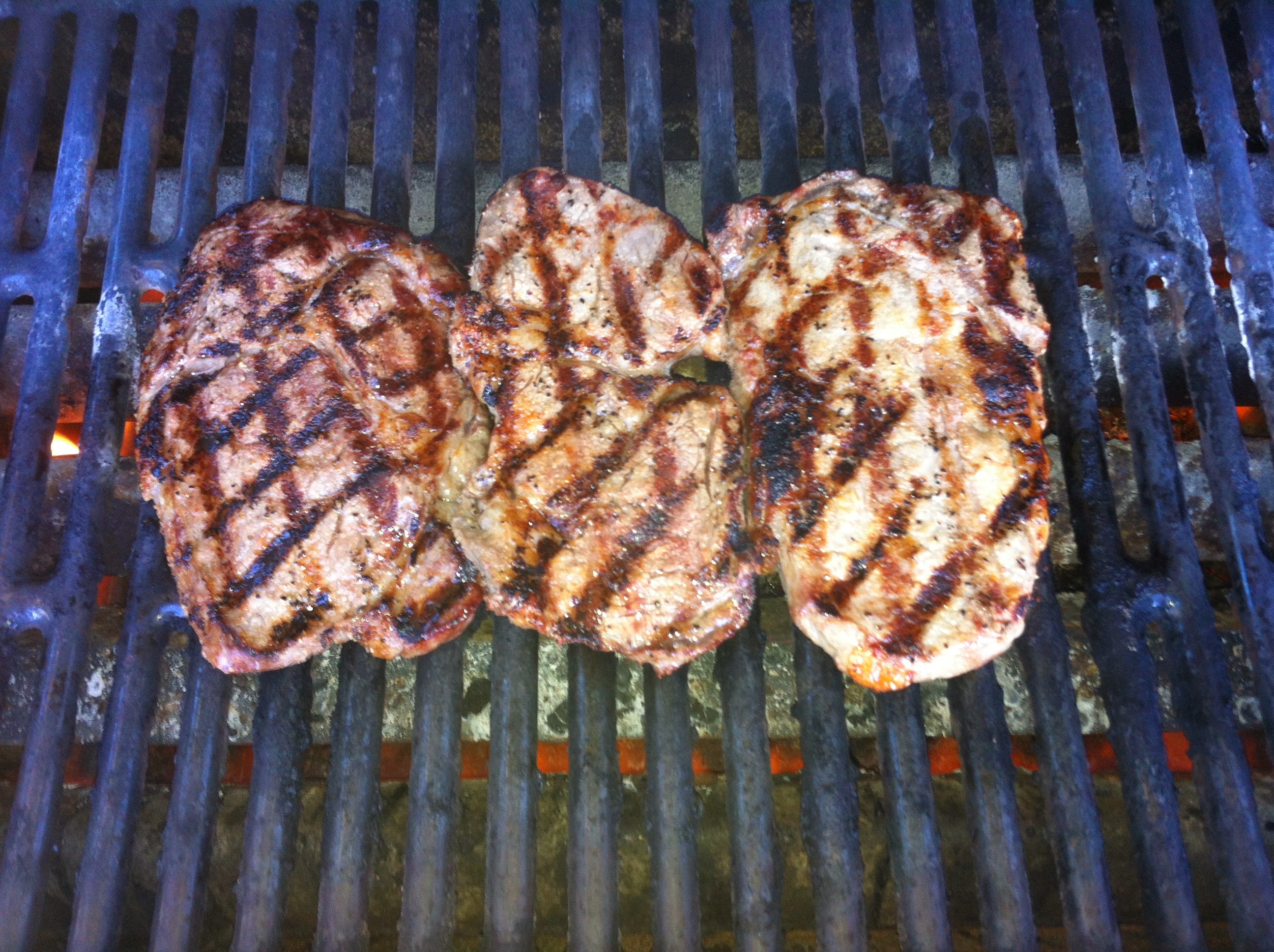 Pork chops on grill photo