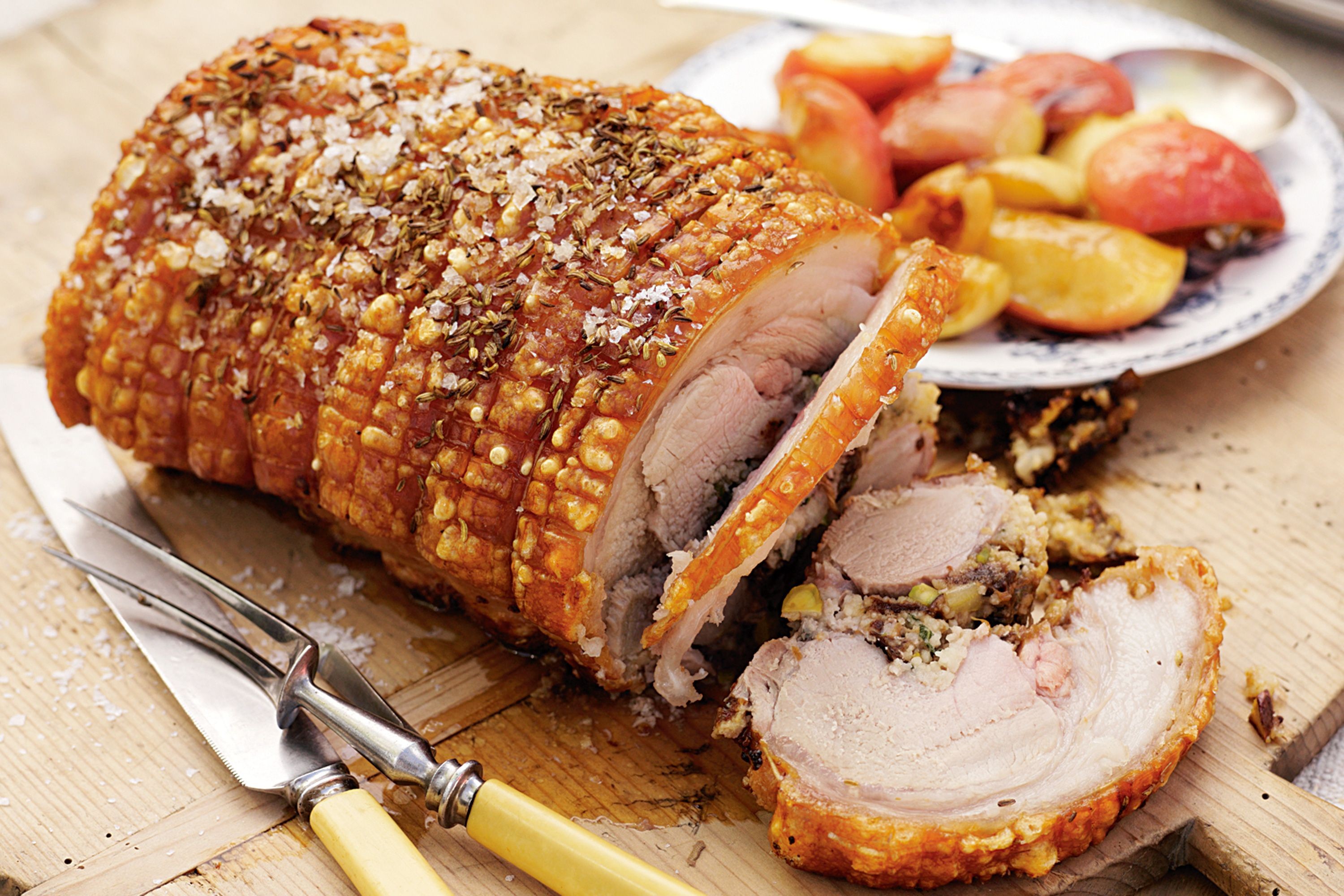 Prune and couscous stuffed roast pork with baby apples