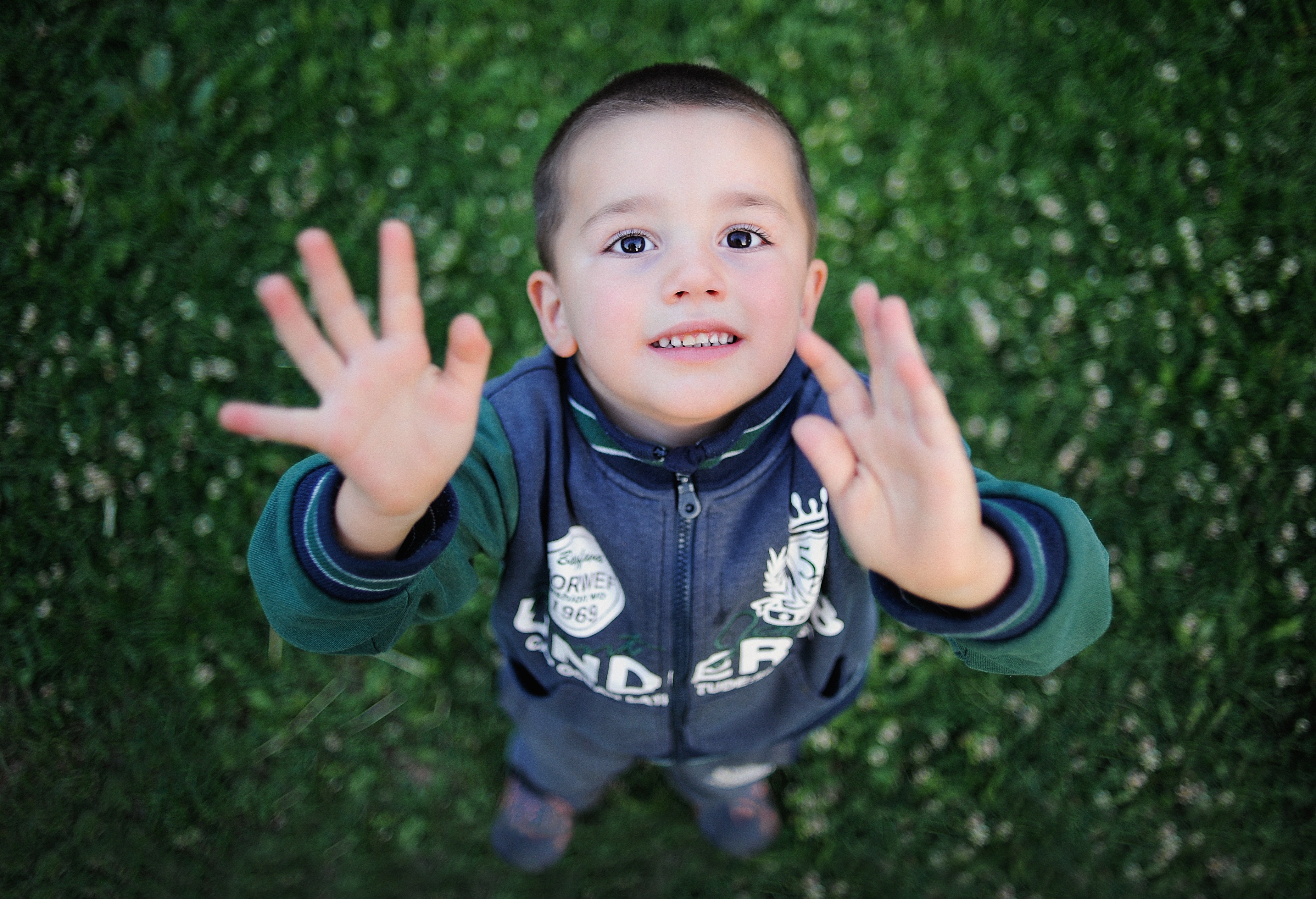 Portrait of smiling boy with arms outstretched photo