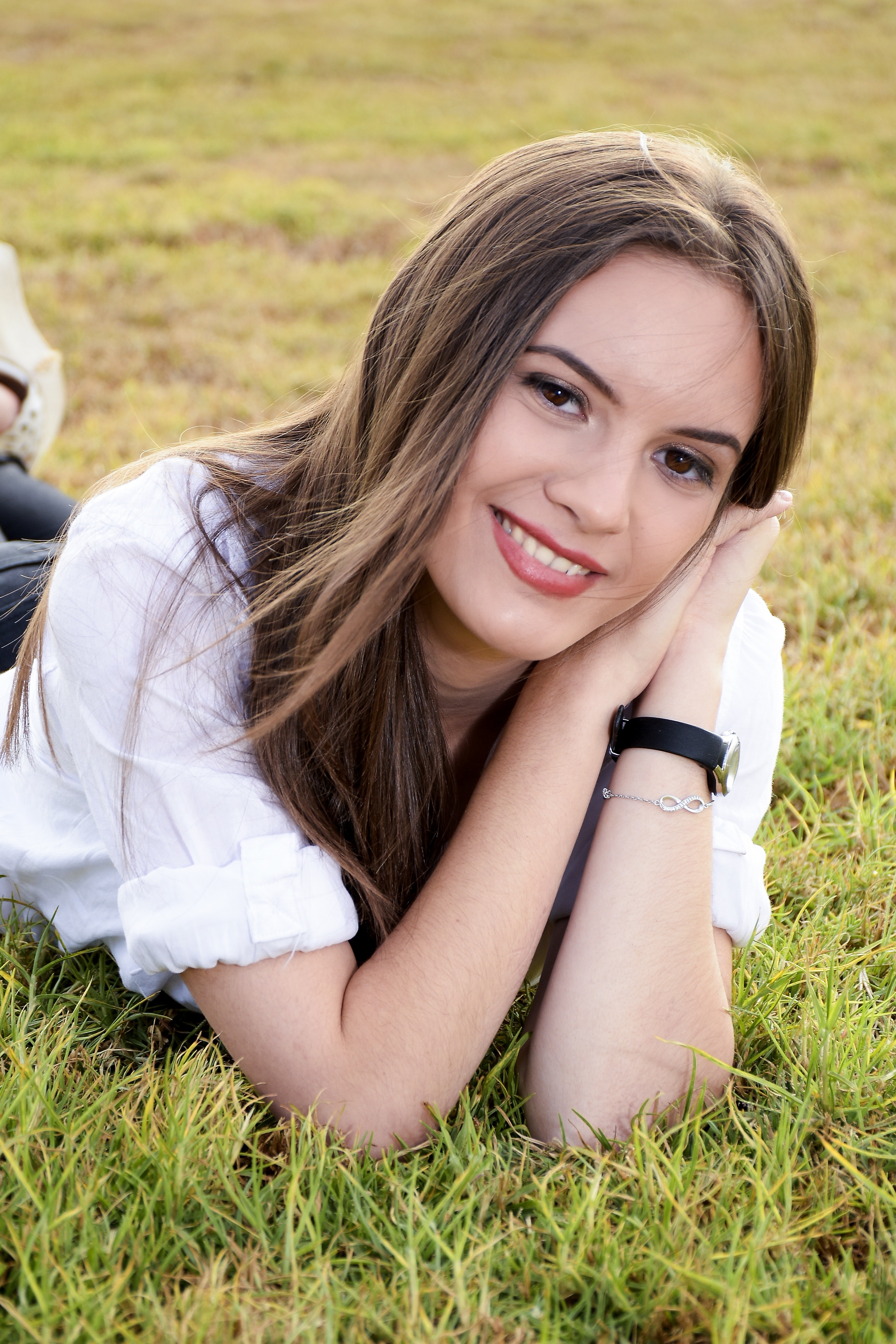 Portrait of young woman lying on grass photo