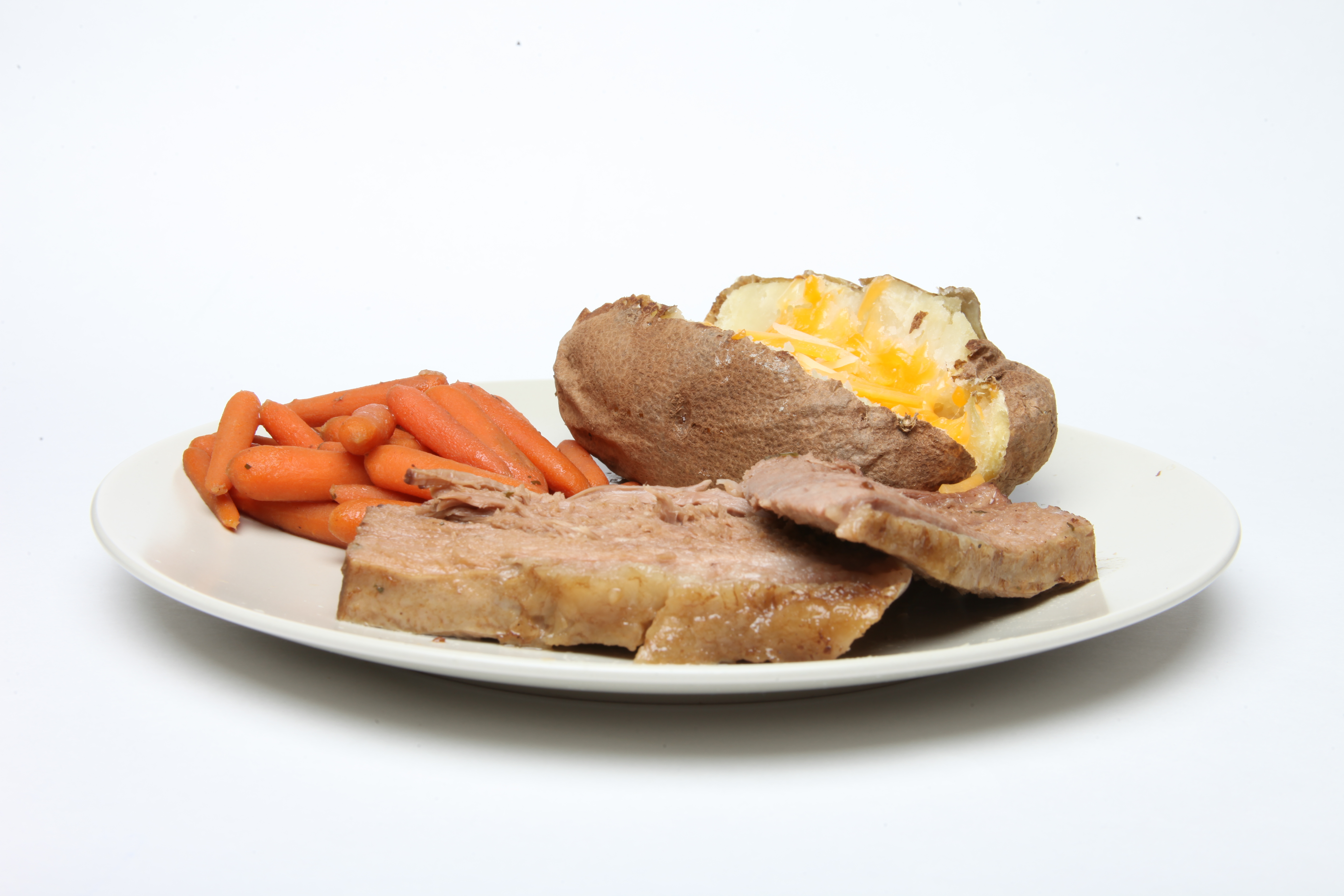 Pot roast, carrots and baked potato photo