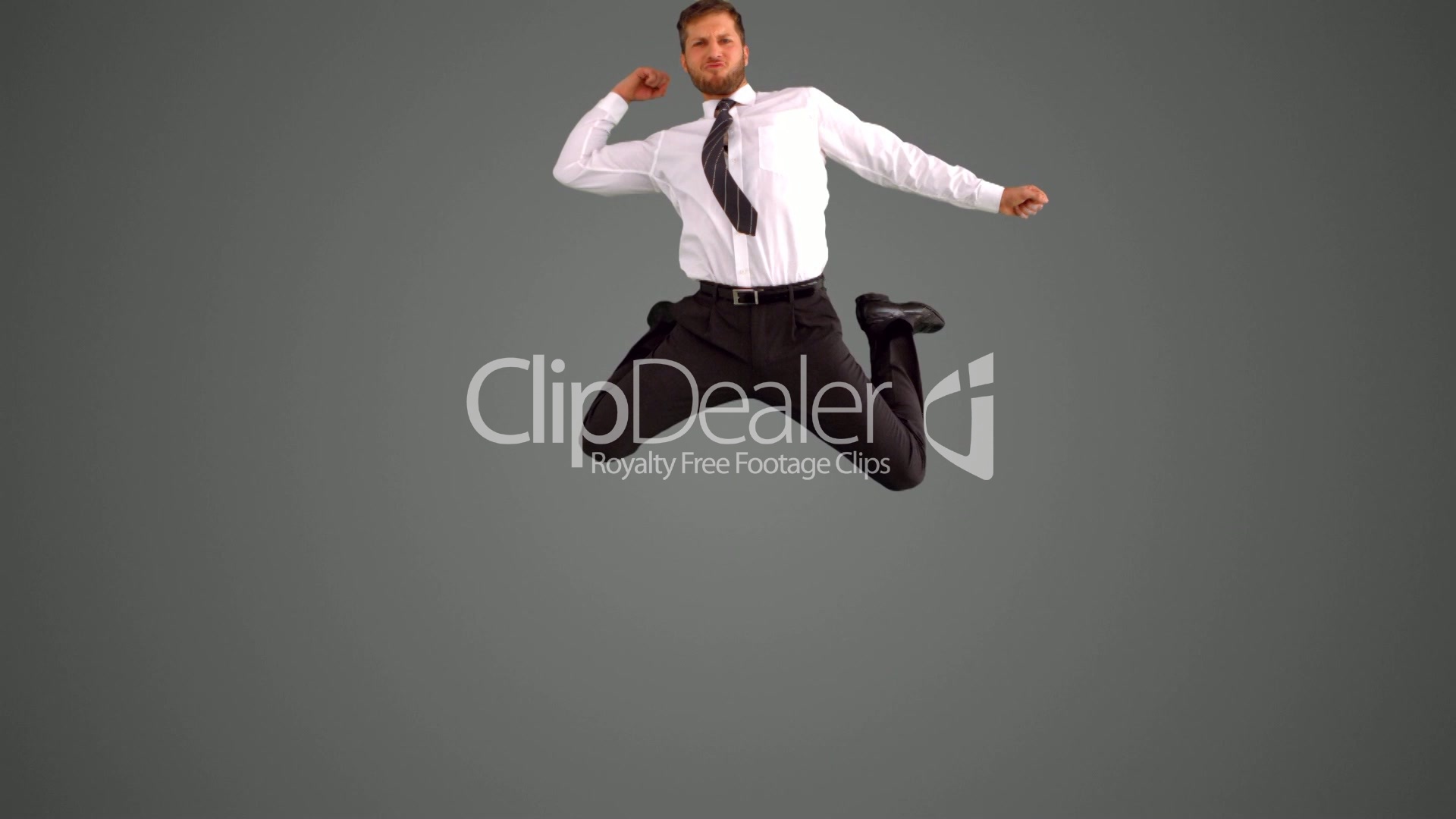 Businessman jumping and punching air on grey background: Royalty ...