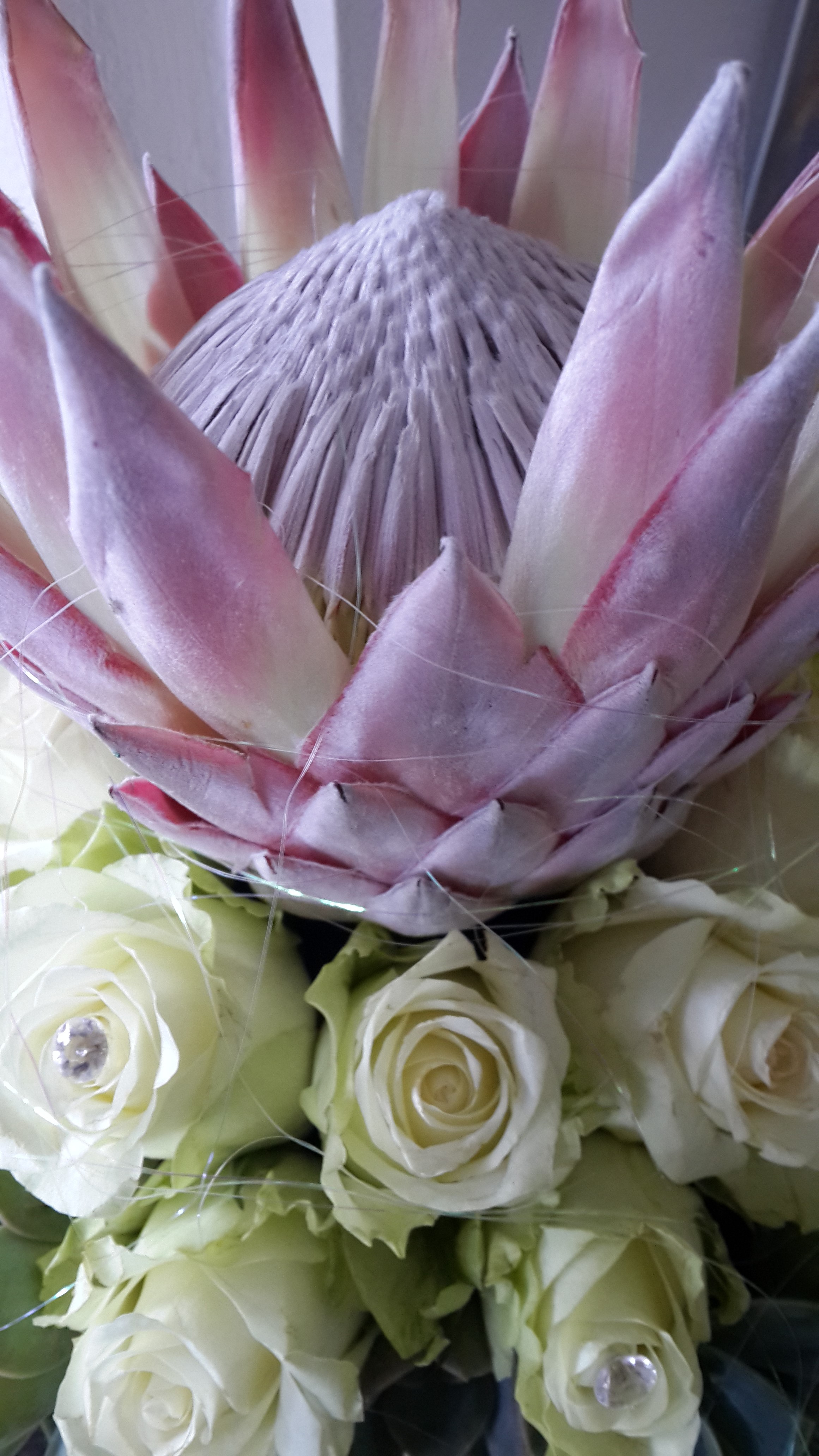 Pink king protea and white rose centre piece | In Full Bloom