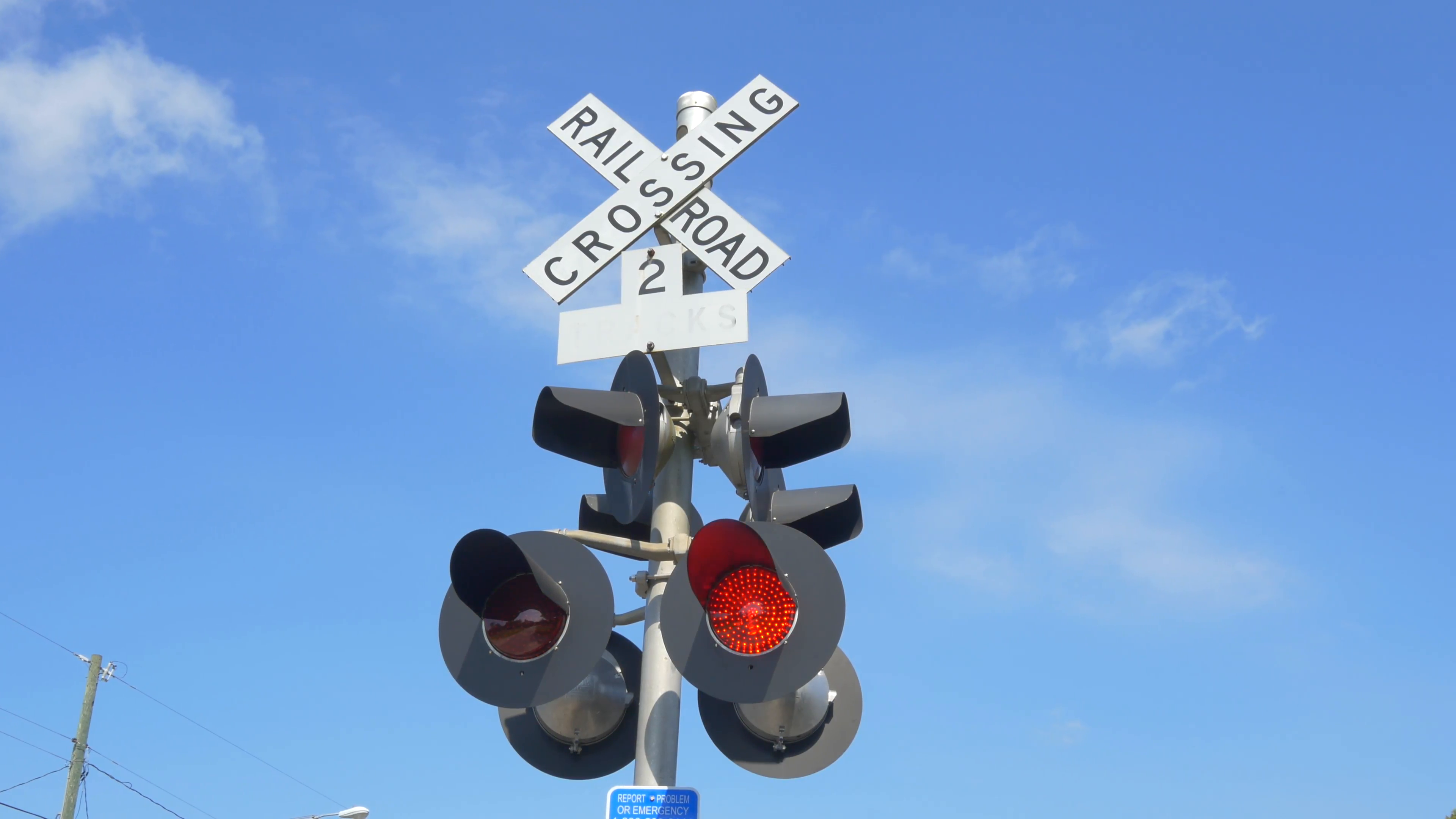 Railroad crossing with flashing red lights warning and announcing ...