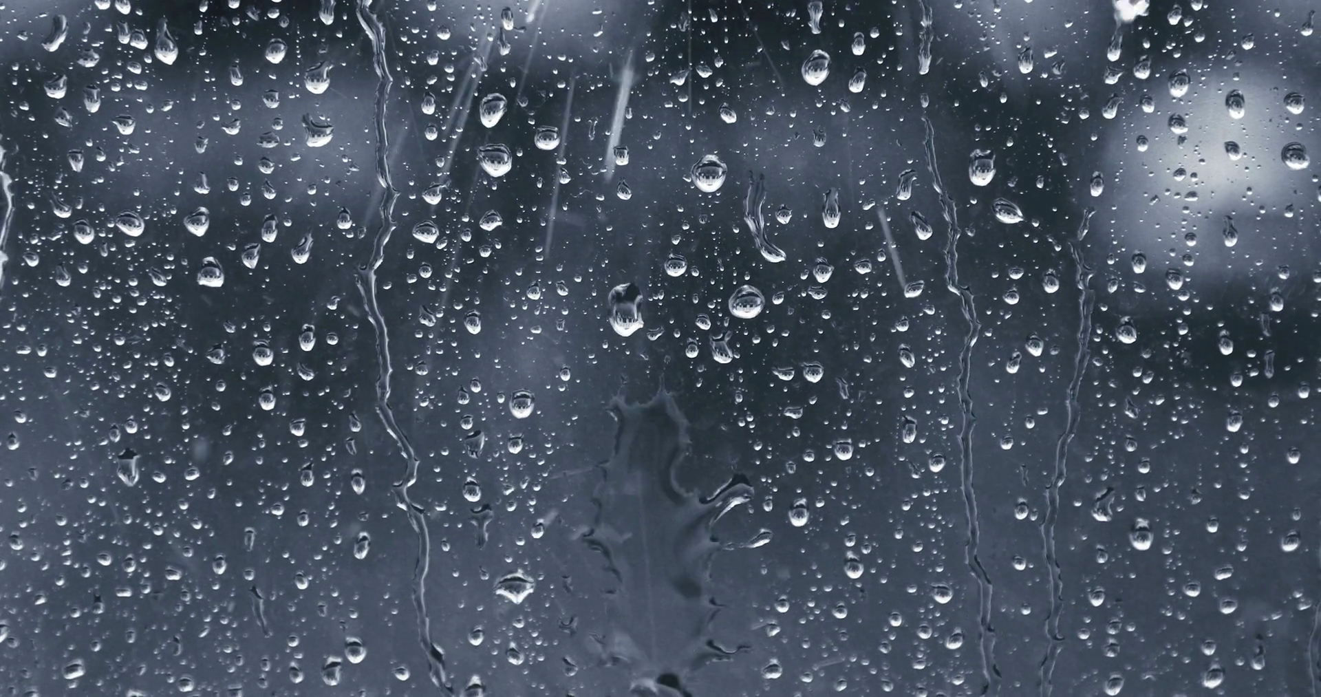 Rain drops running down a window pane. Blue tint Stock Video Footage ...