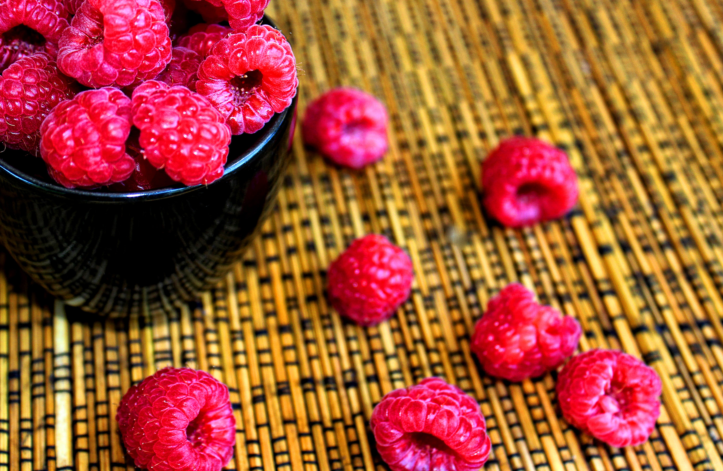 Raspberries on a black cup photo
