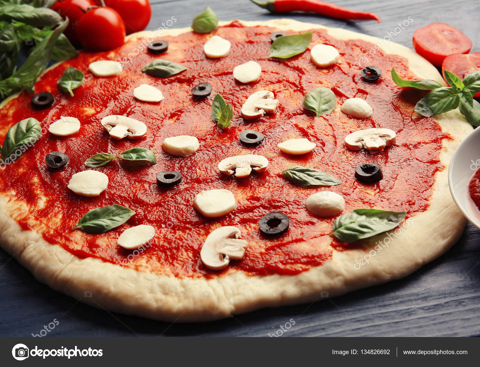 Raw pizza dough with ingredients — Stock Photo © belchonock #134826692