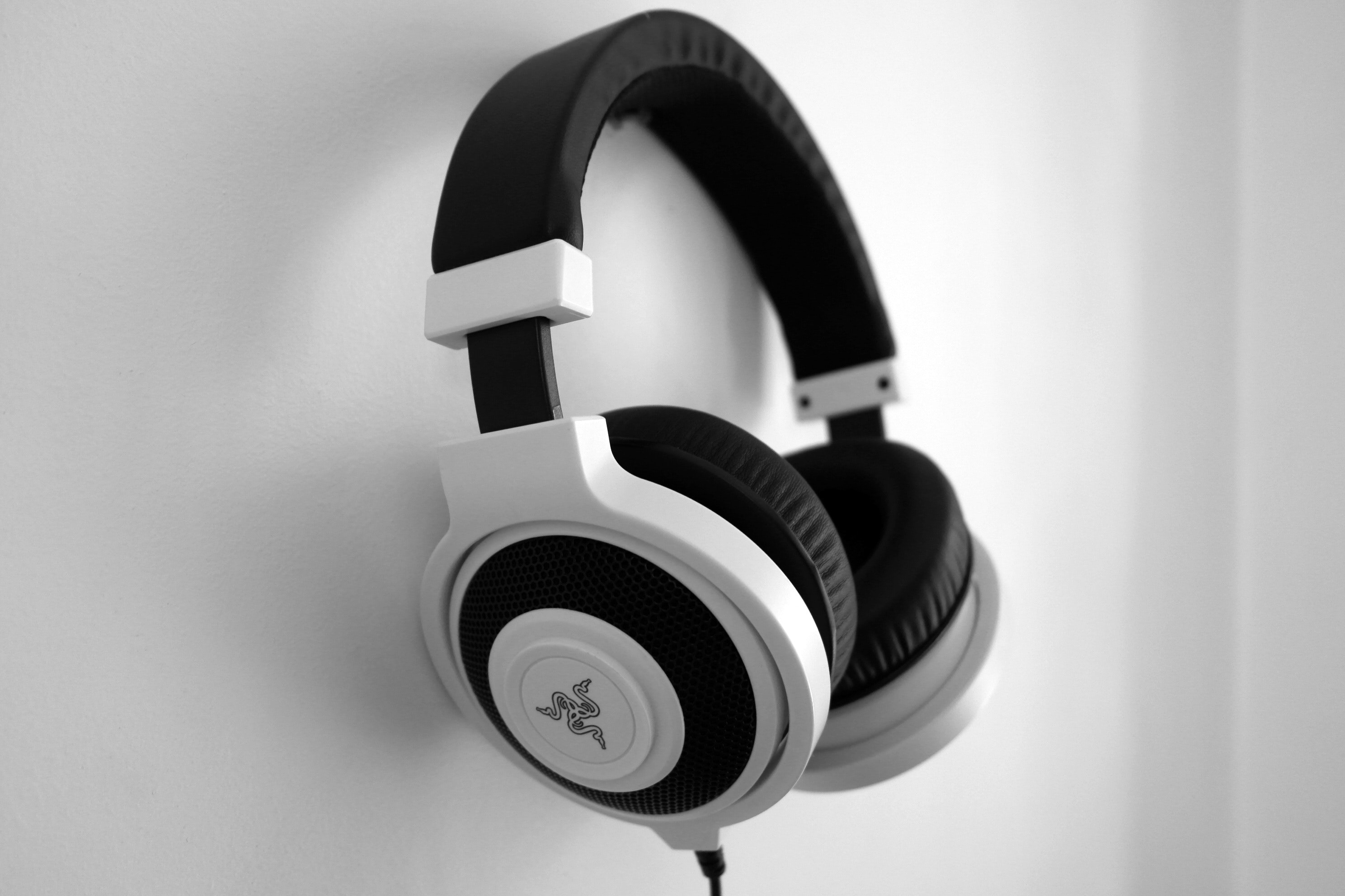 Black and White Razer Gaming Headset Hanging on White Painted Wall ...