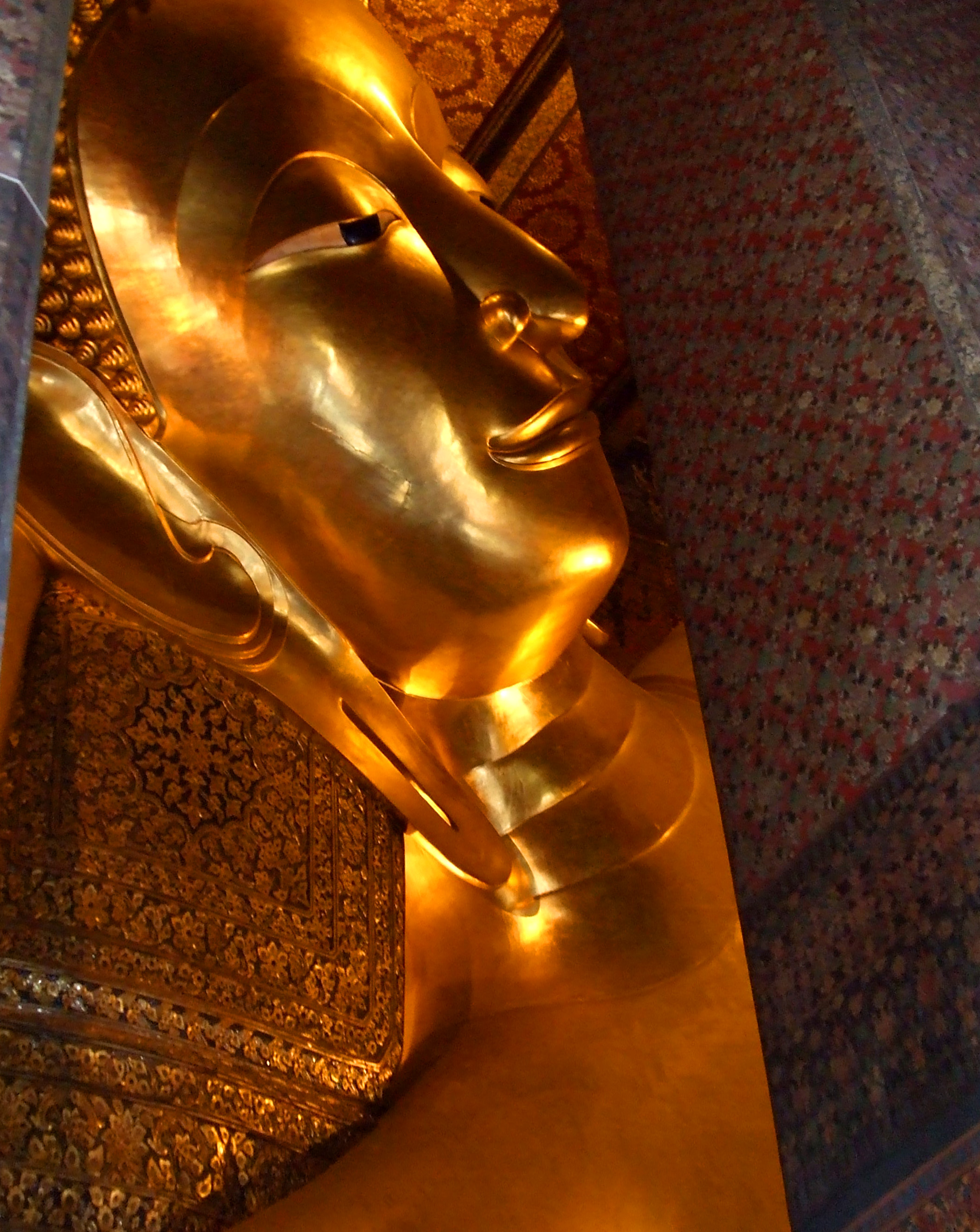 Reclining buddha gold statue face photo