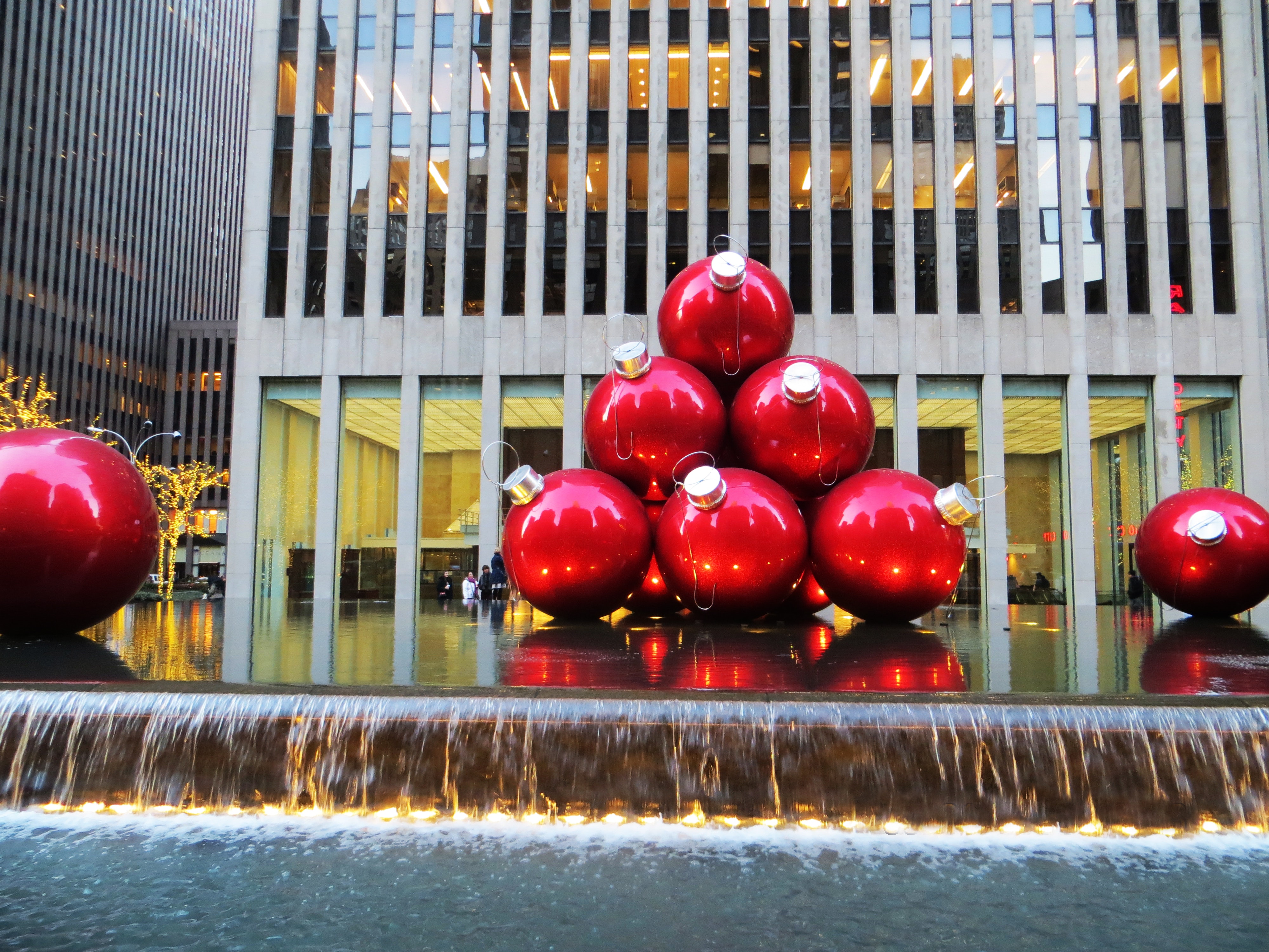 Red baubles near grey high-rise building photo