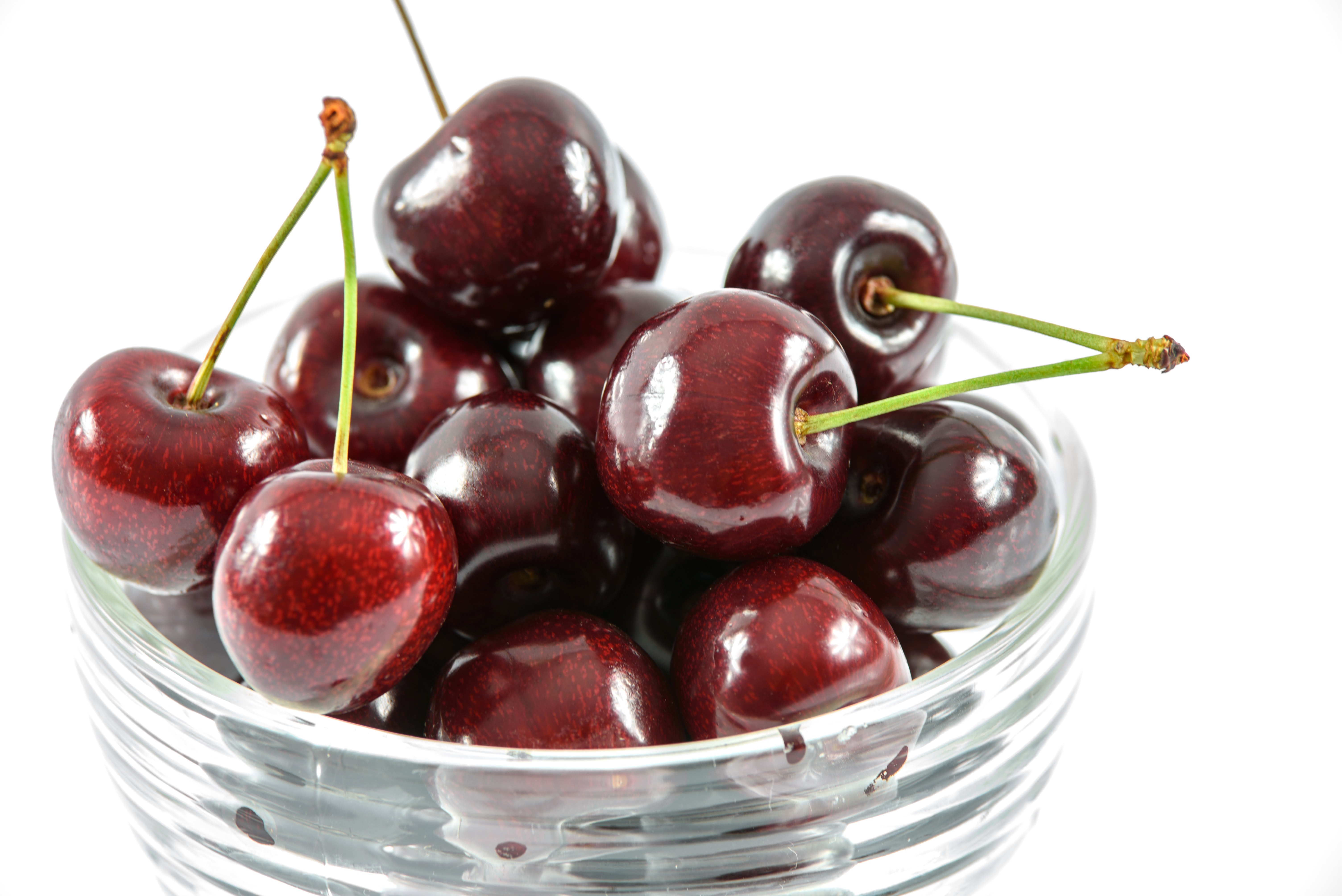Red cherry in clear glass bowl photo