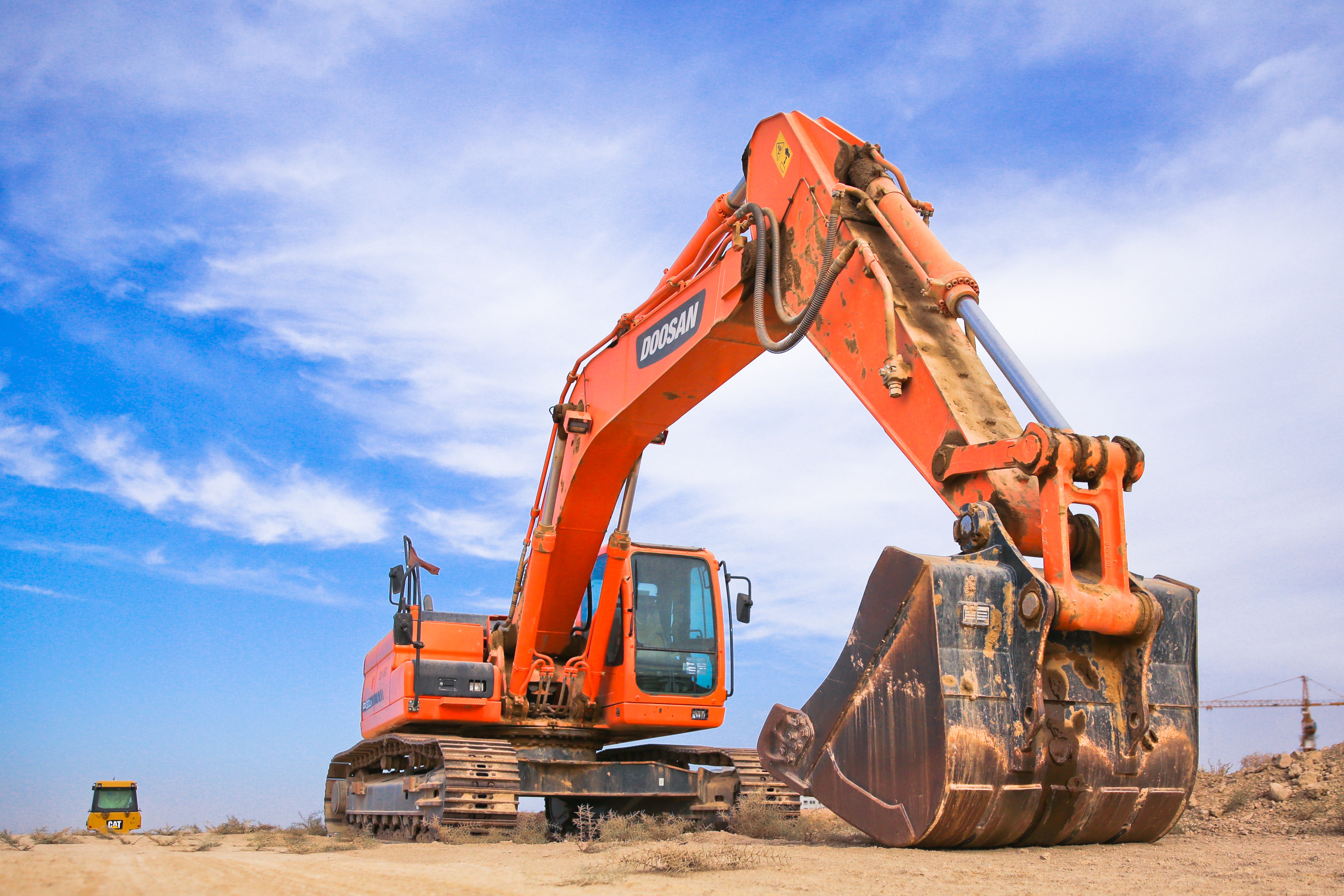 Red excavator on dry field photo