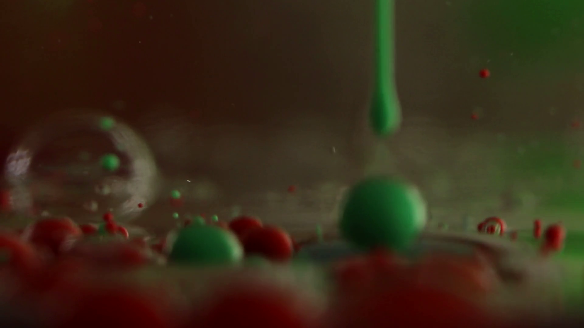 Opaque red bubbles float in clear gel, and green gel is squeezed in ...