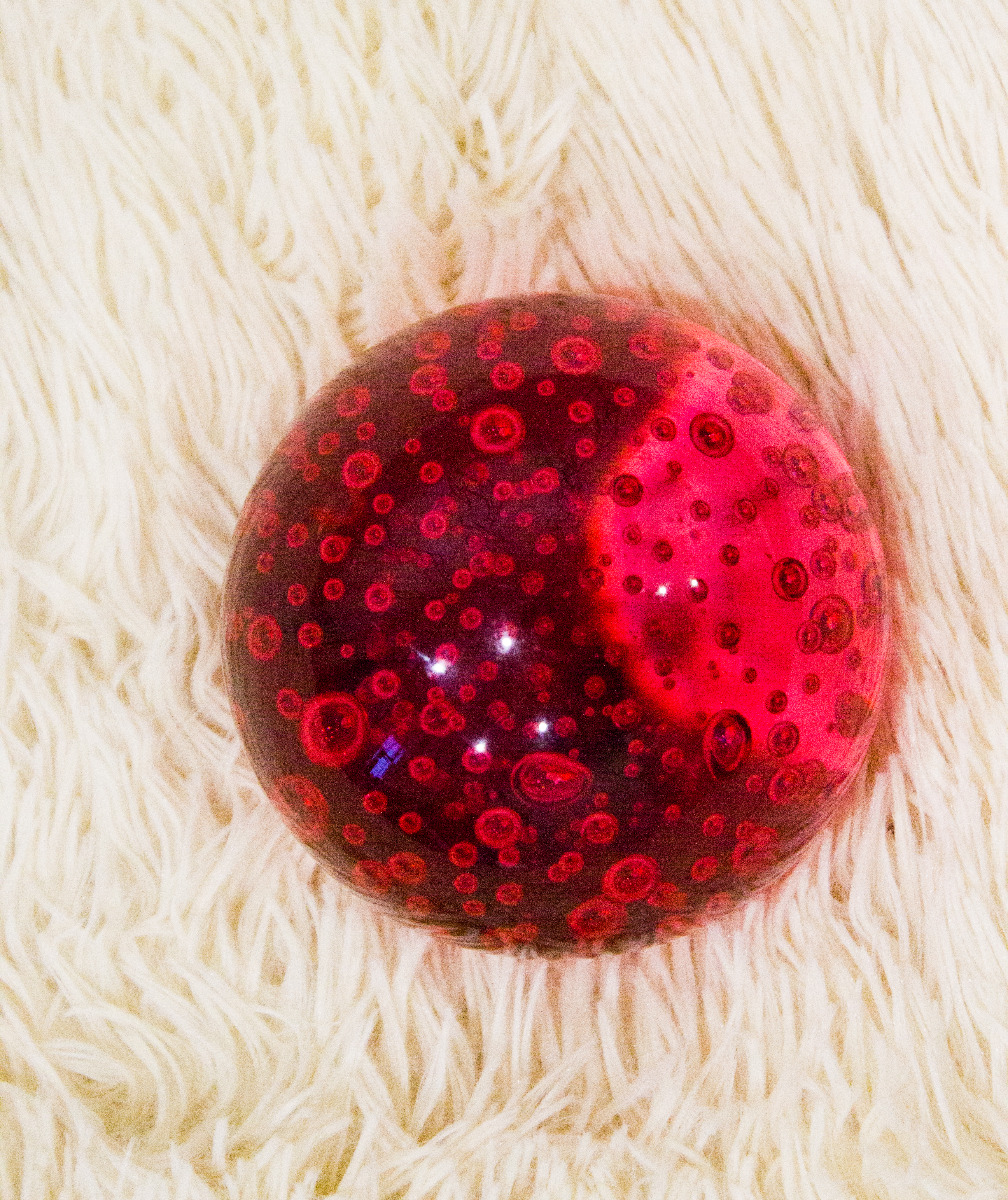 Red glass ball on white background photo
