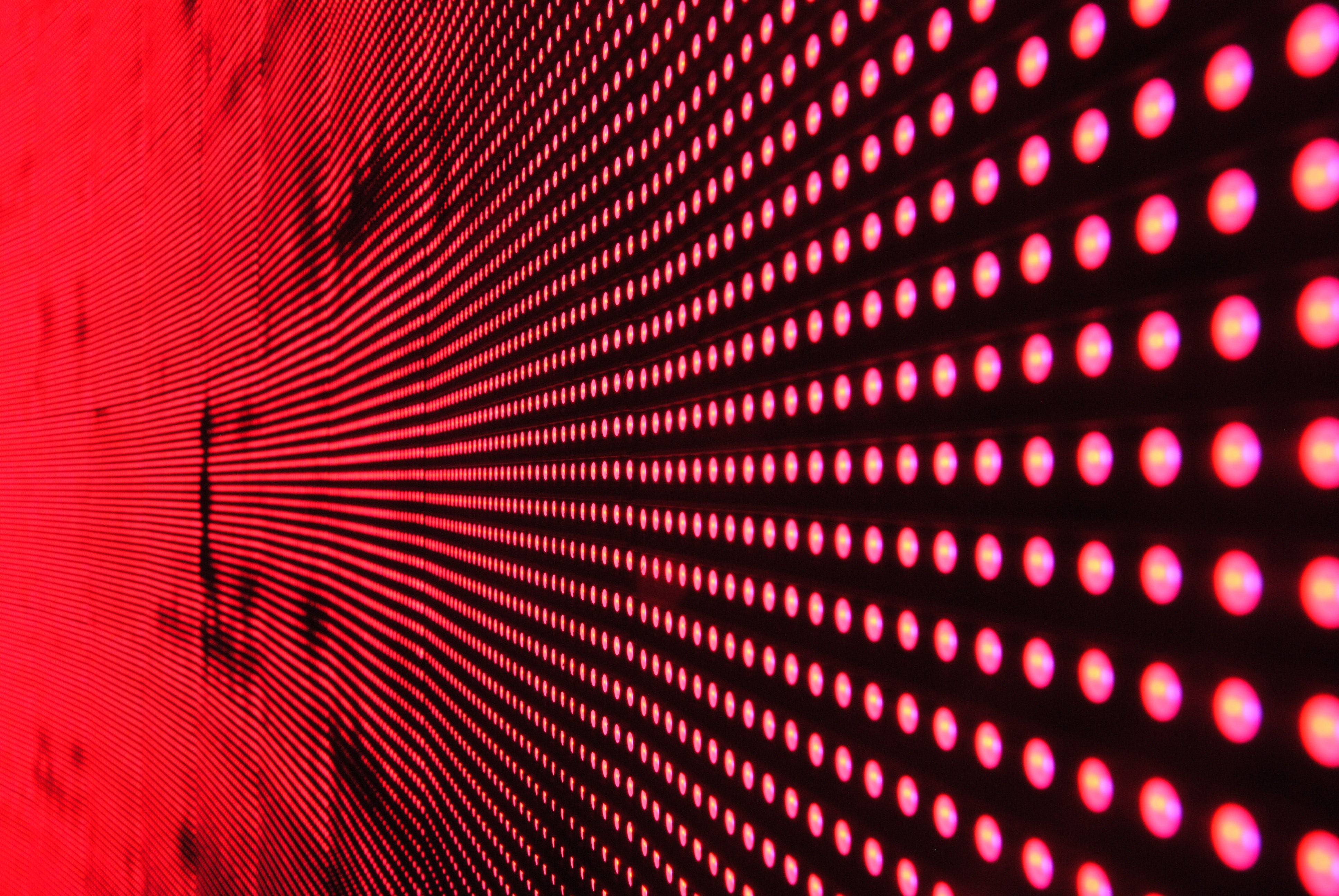 Red lights in line on black surface photo