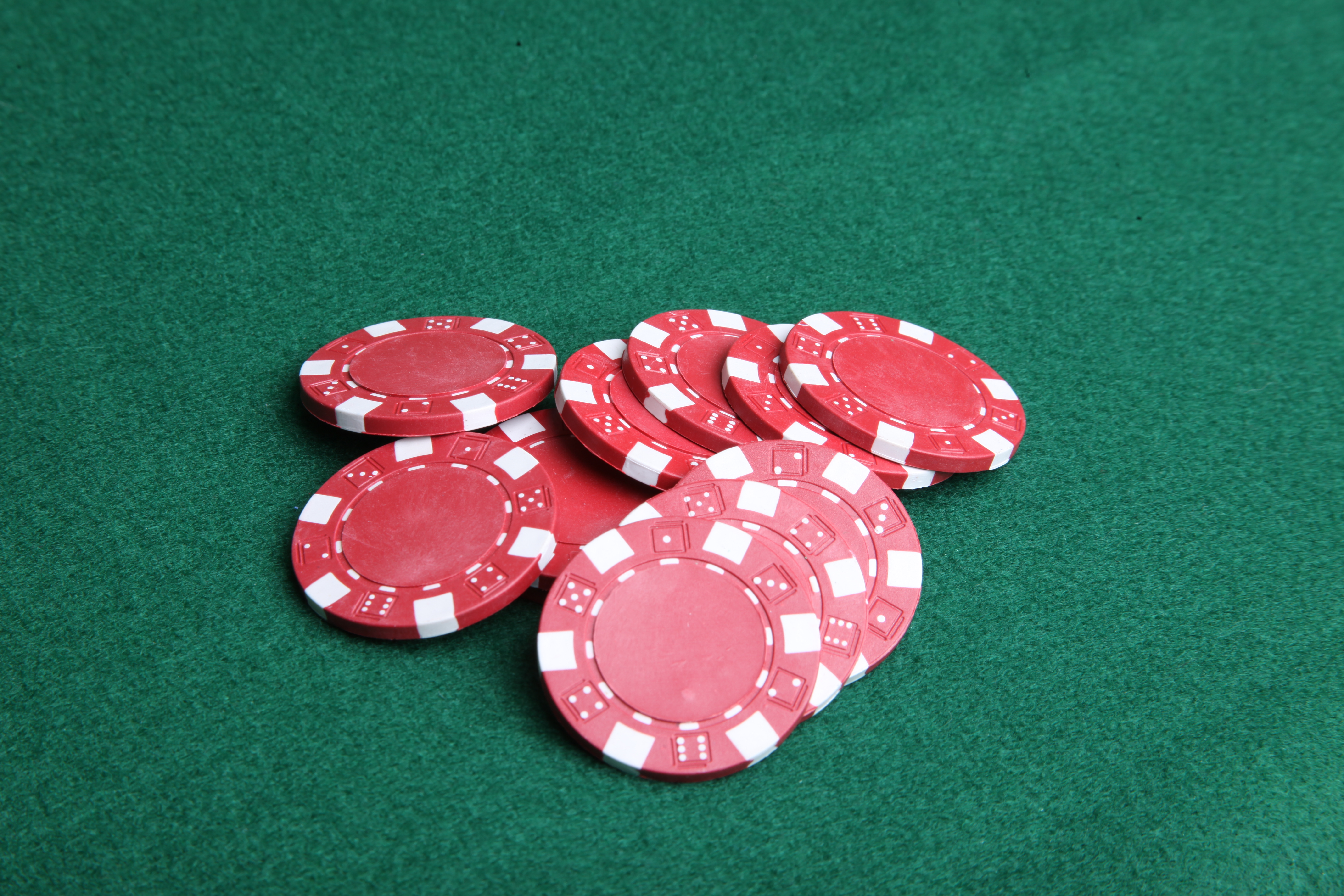 Red poker chips on green felt. photo