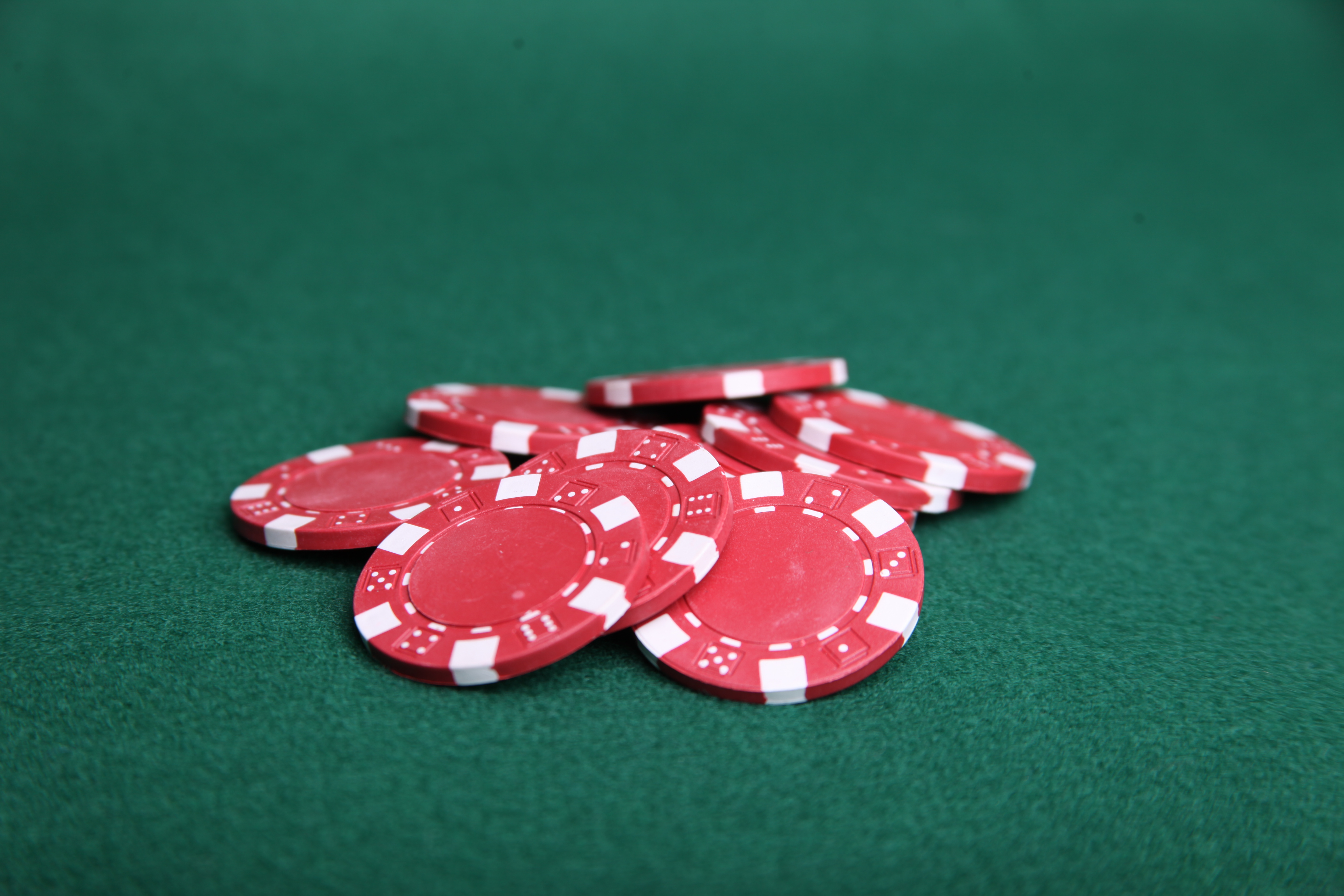 Red poker chips on green felt. photo