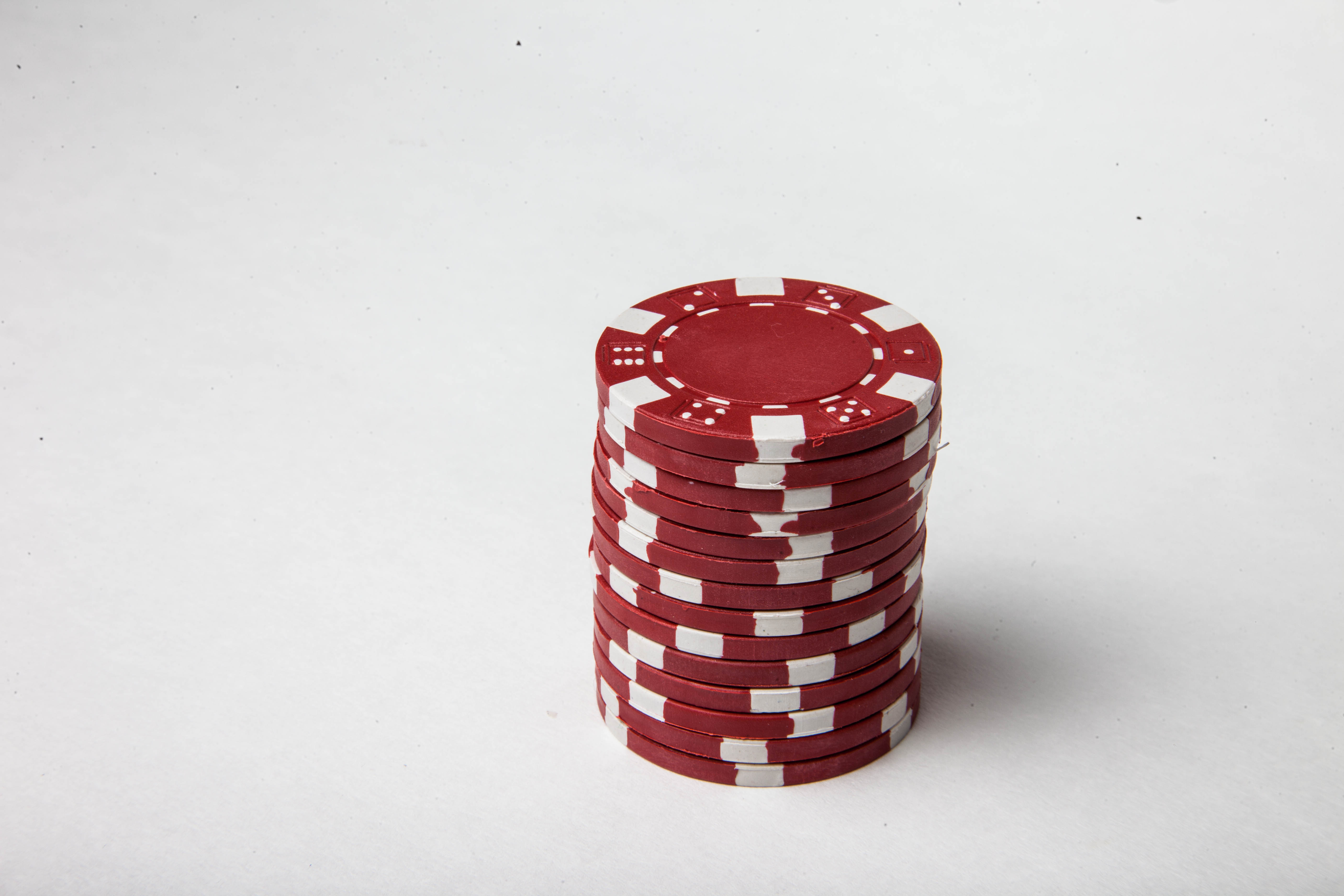 Red poker chips on white background photo