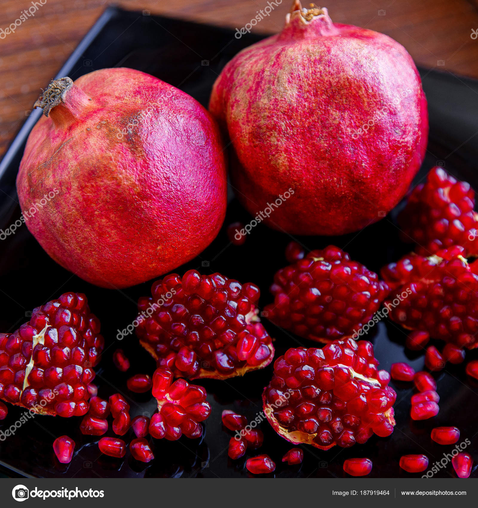Some ripe juicy red pomegranate fruit on the plate. (Punica gran ...