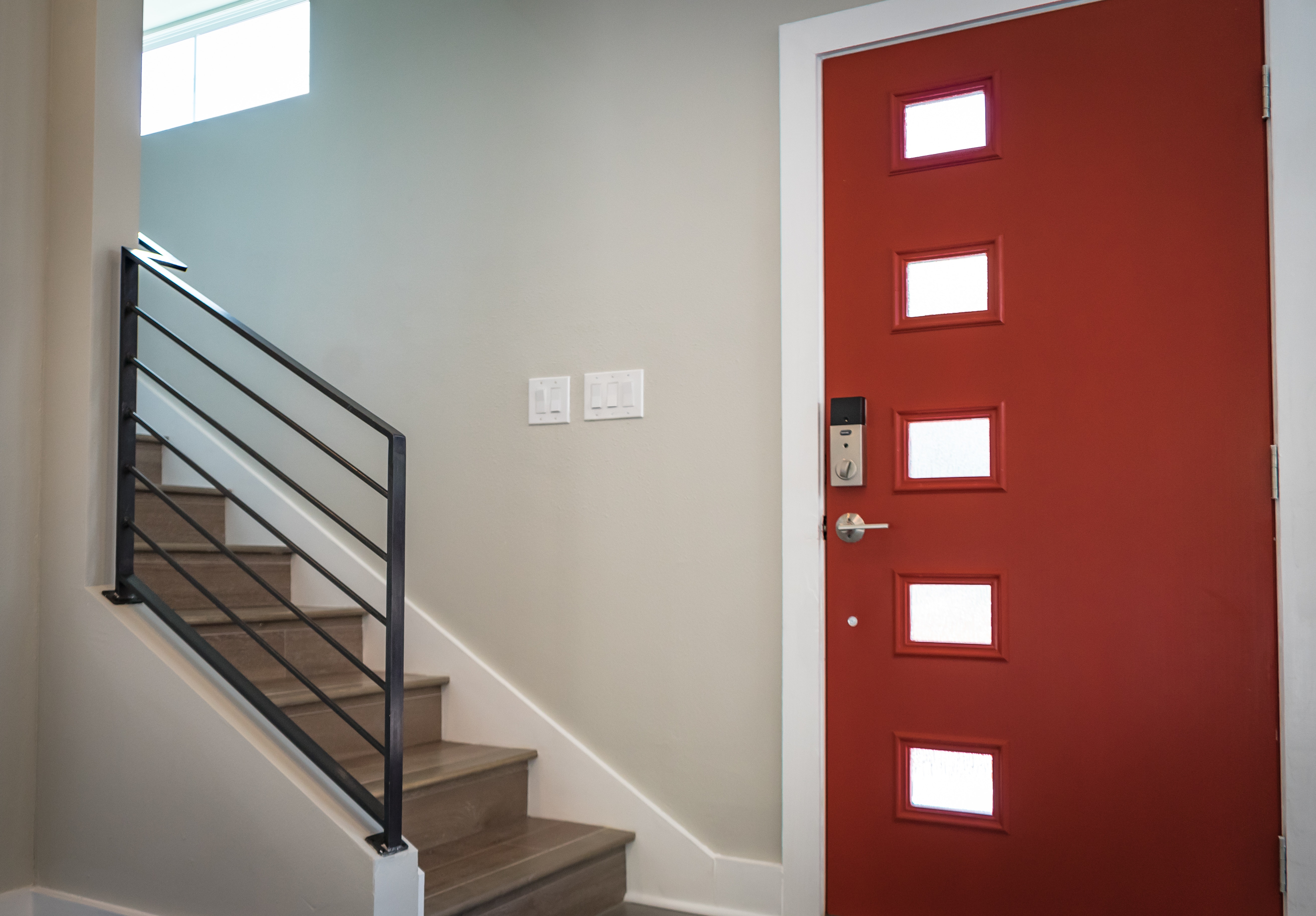 Red wooden door beside stairs photo
