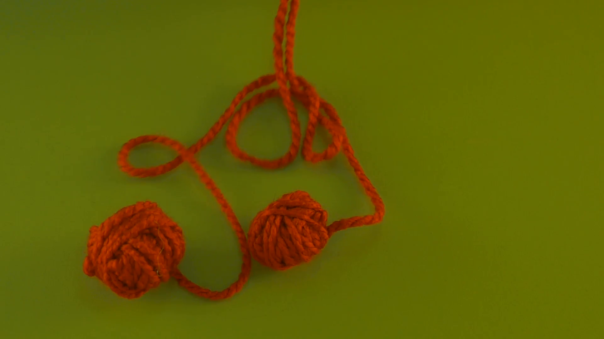 Two Red Yarn Balls Are Unraveling on Green Screen Colorful Tangle of ...