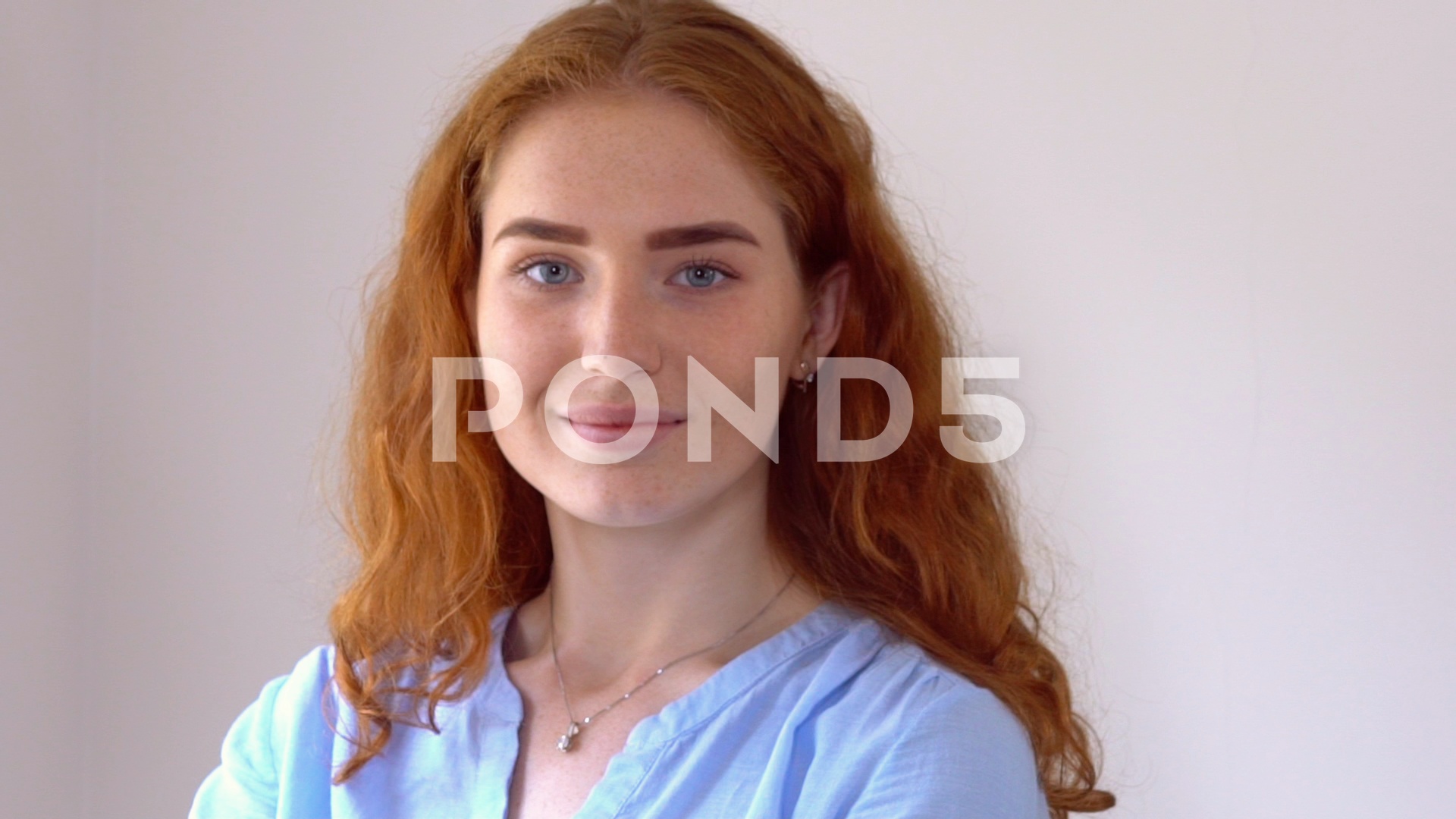 Video: Redheaded businesswoman winks slowmotion. ~ #76758784