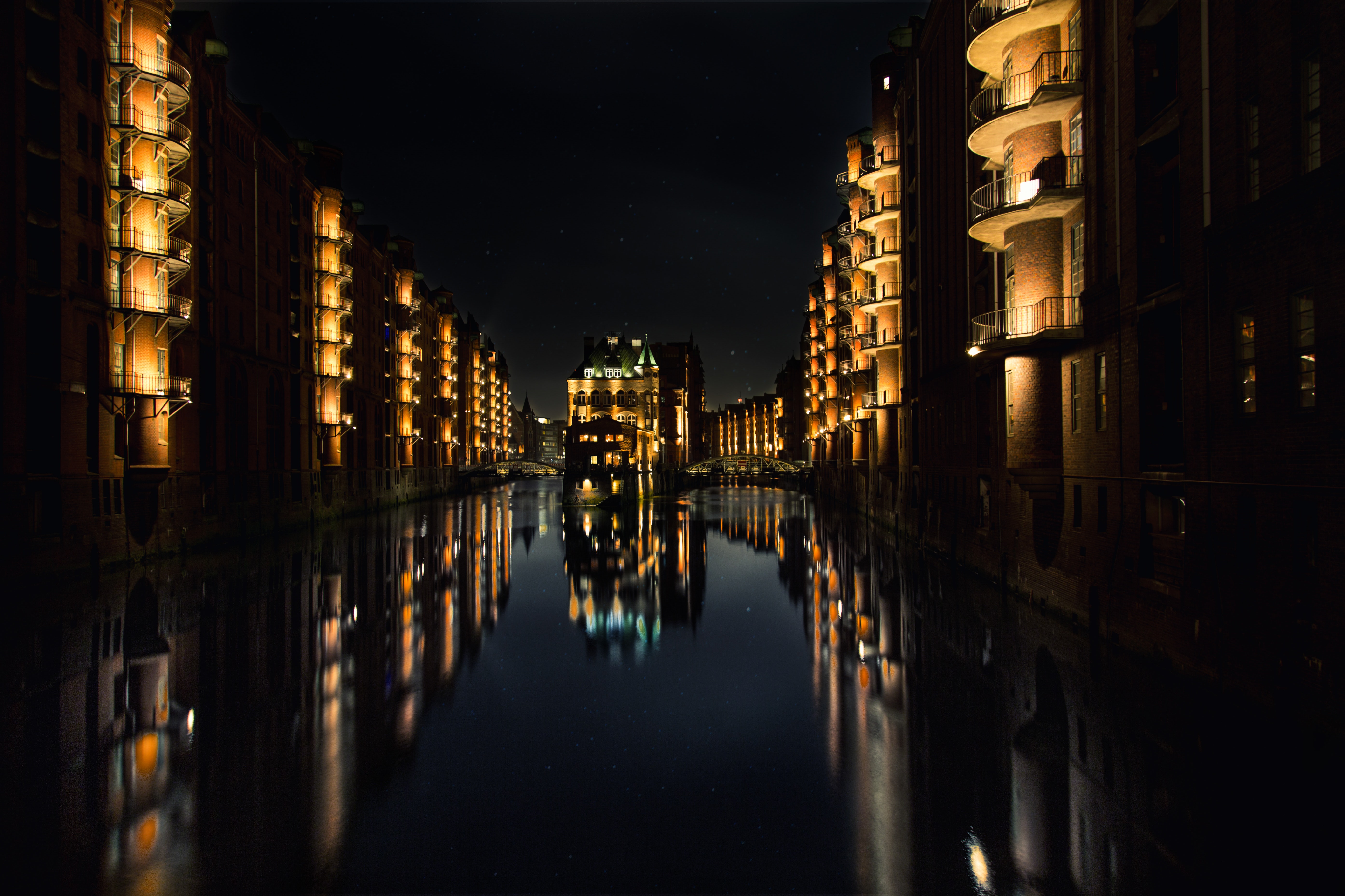 Reflection of buildings on water during nighttime photo