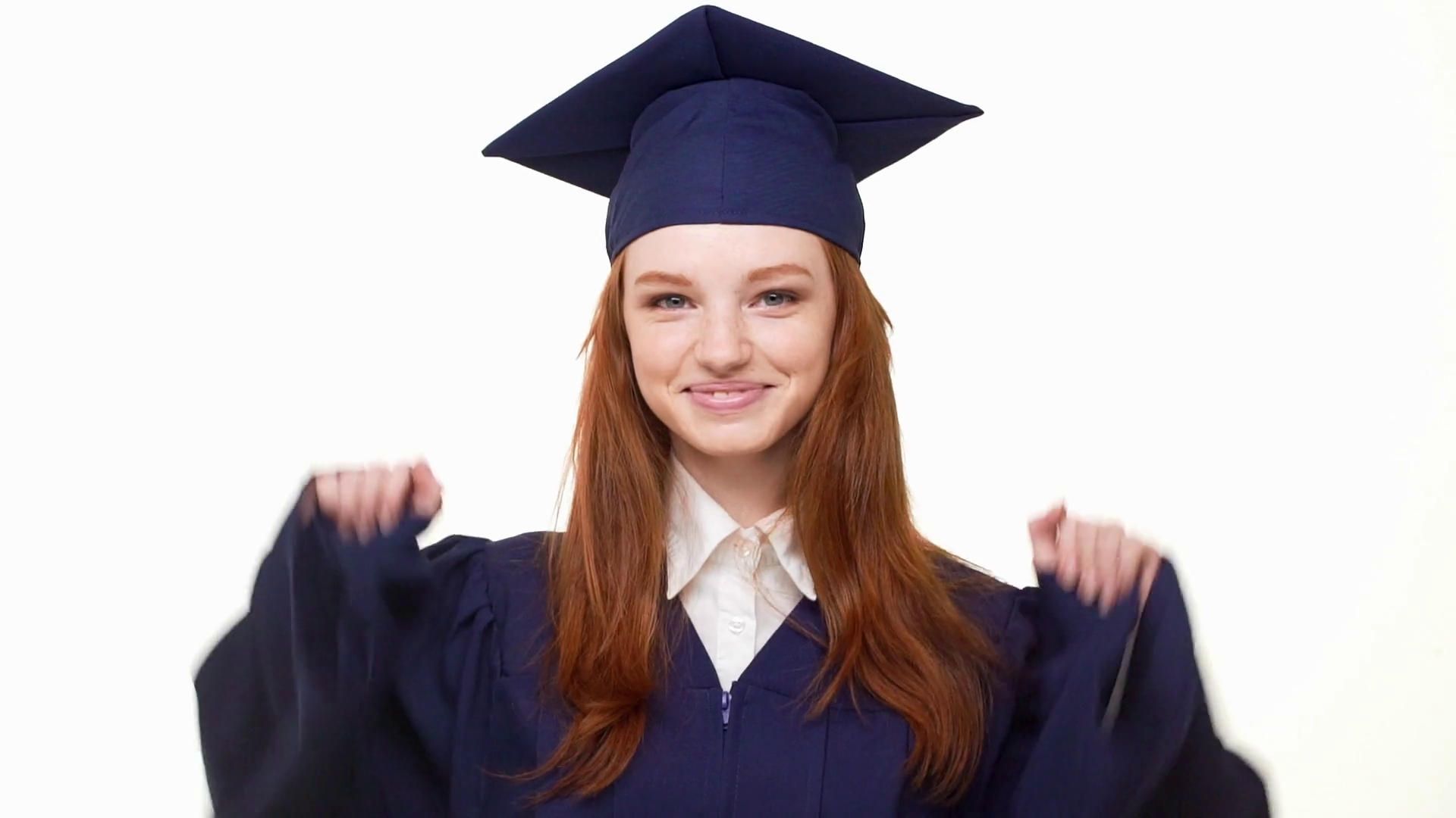 Young attractive Caucasian redhead graduate girl in blue academical ...