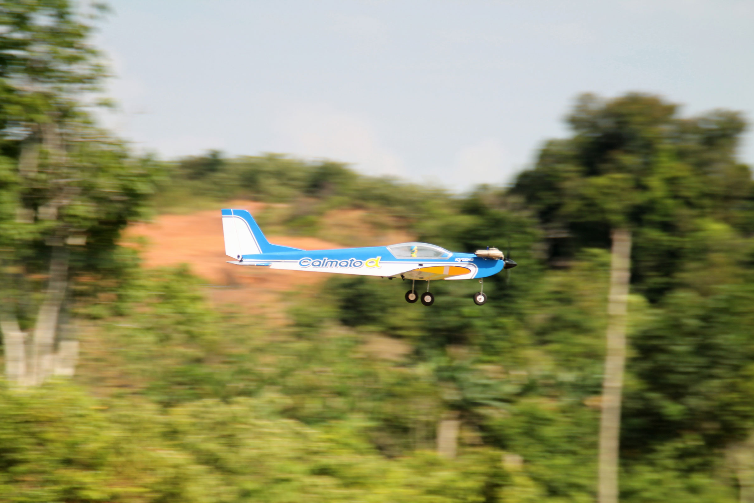 Remote controlled airplane passing photo