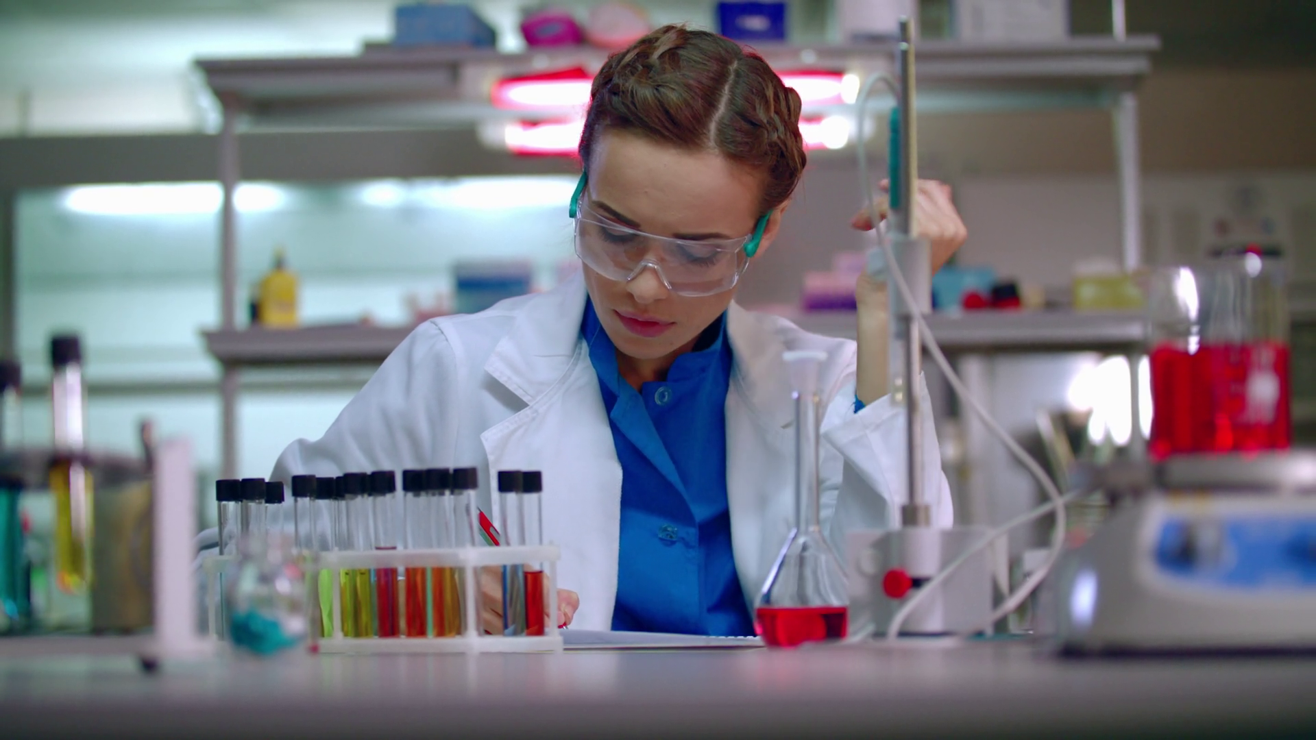 Woman researcher working in lab. Female researcher writing research ...