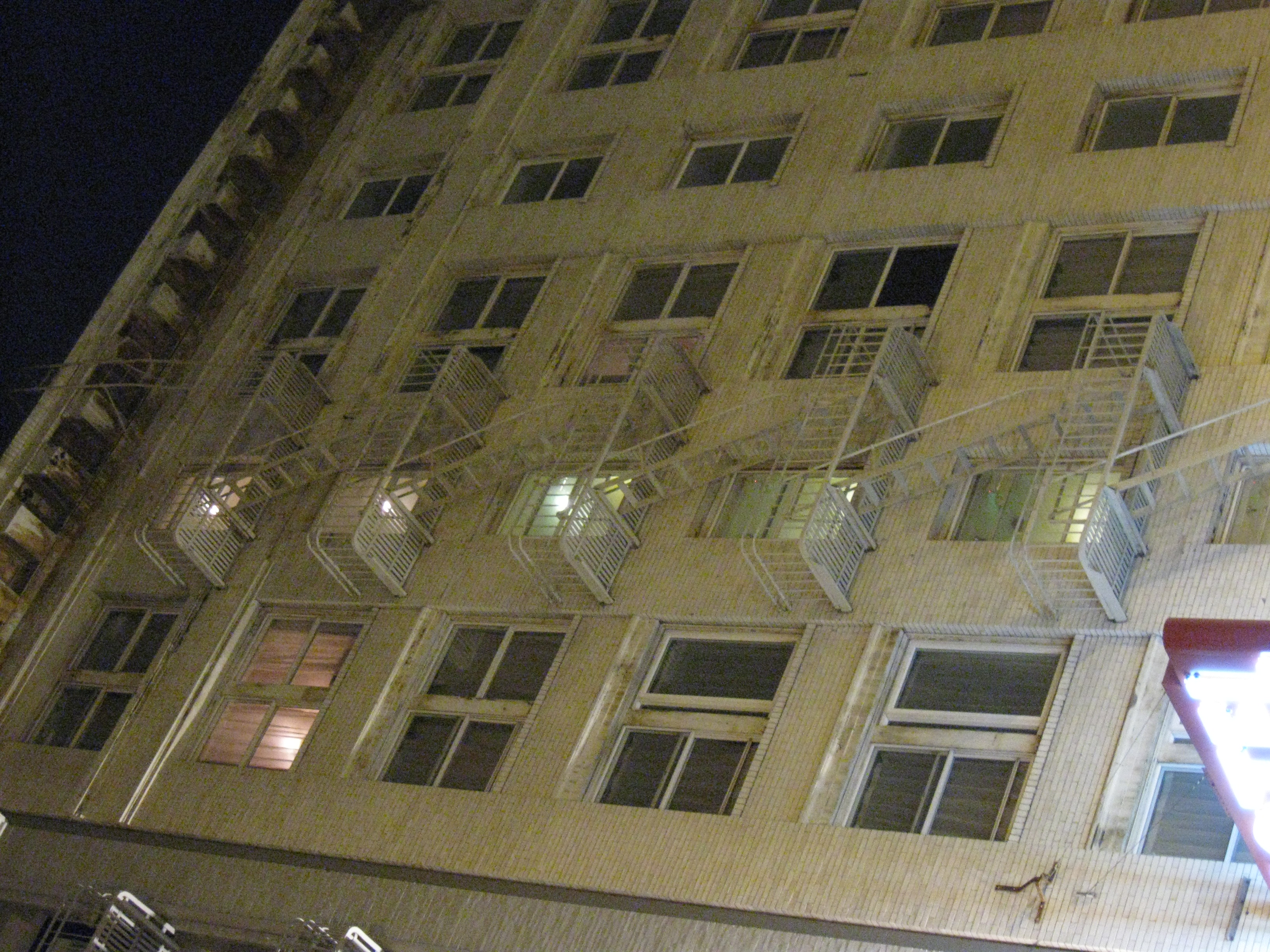 Residential building with fire escape at night in san francisco photo