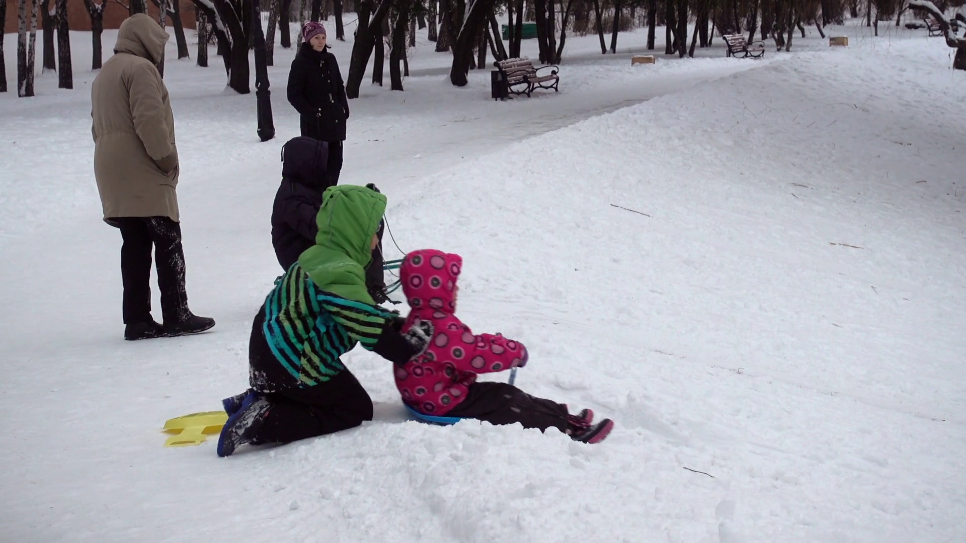 Kiev/January 2017. Children in the winter on the hill. Children ride ...