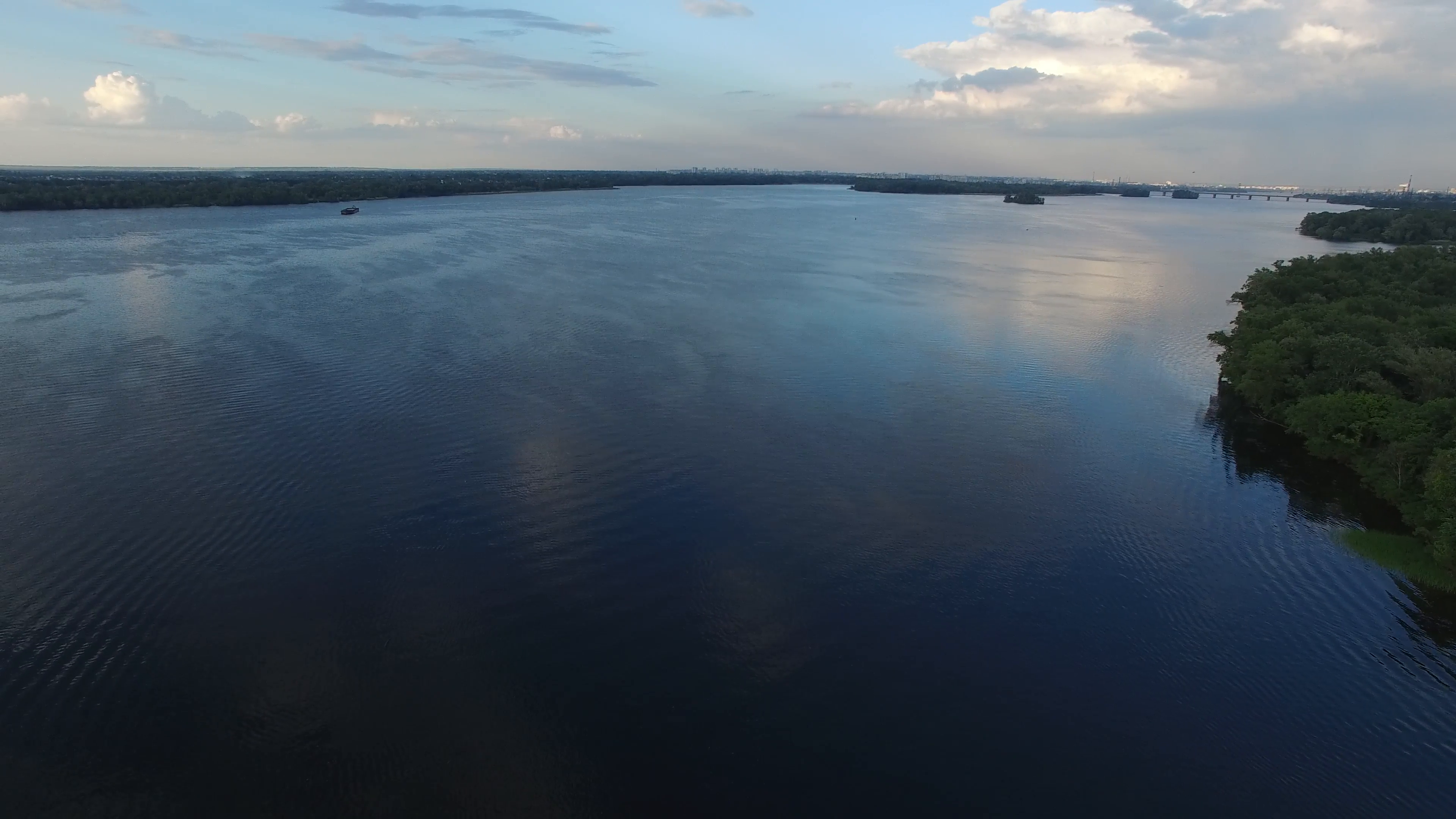 Aerial view, flight forward. Big river during sunset. Blue sky ...