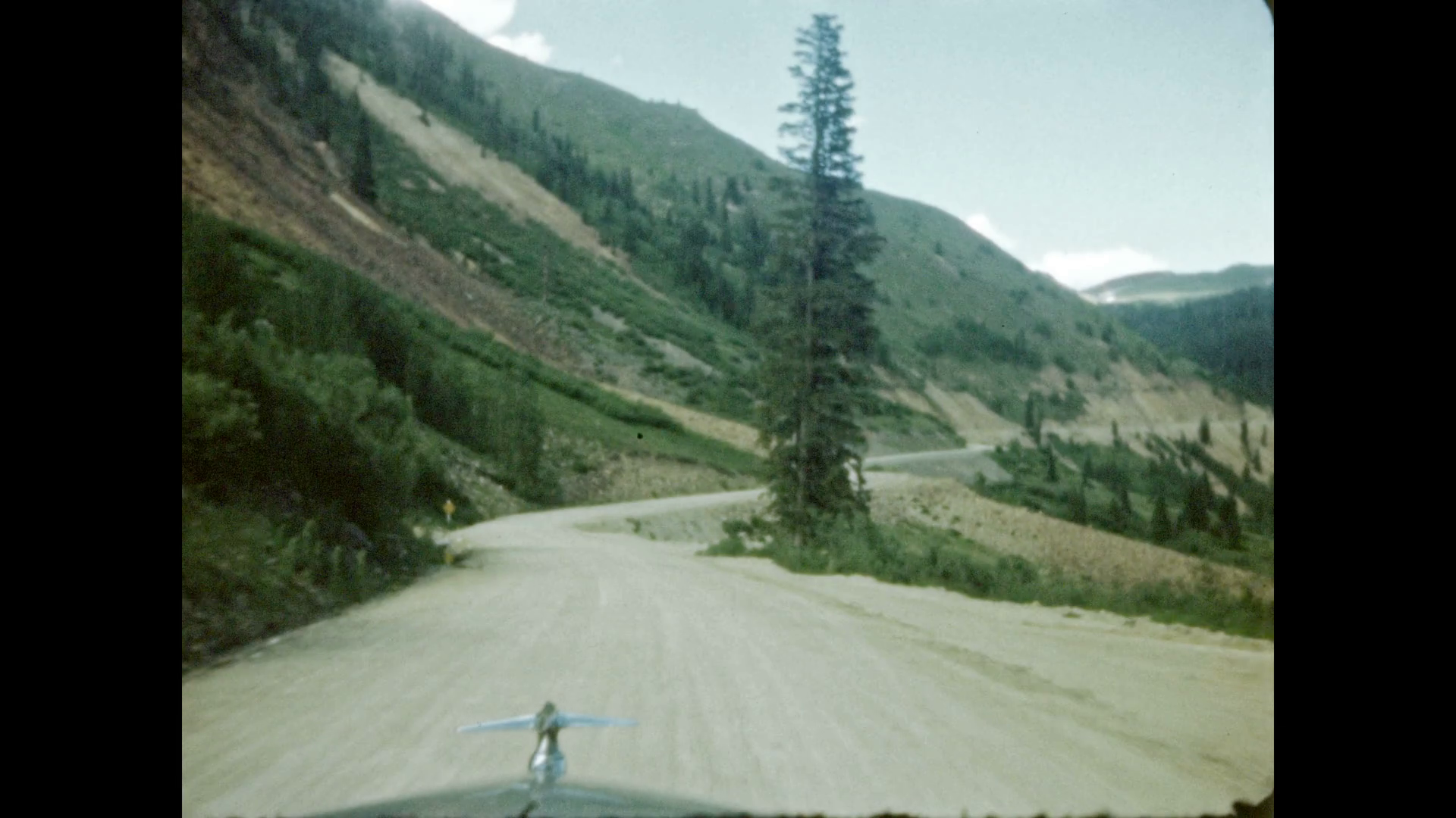 1940s: Car drives along mountain road. Stock Video Footage - VideoBlocks